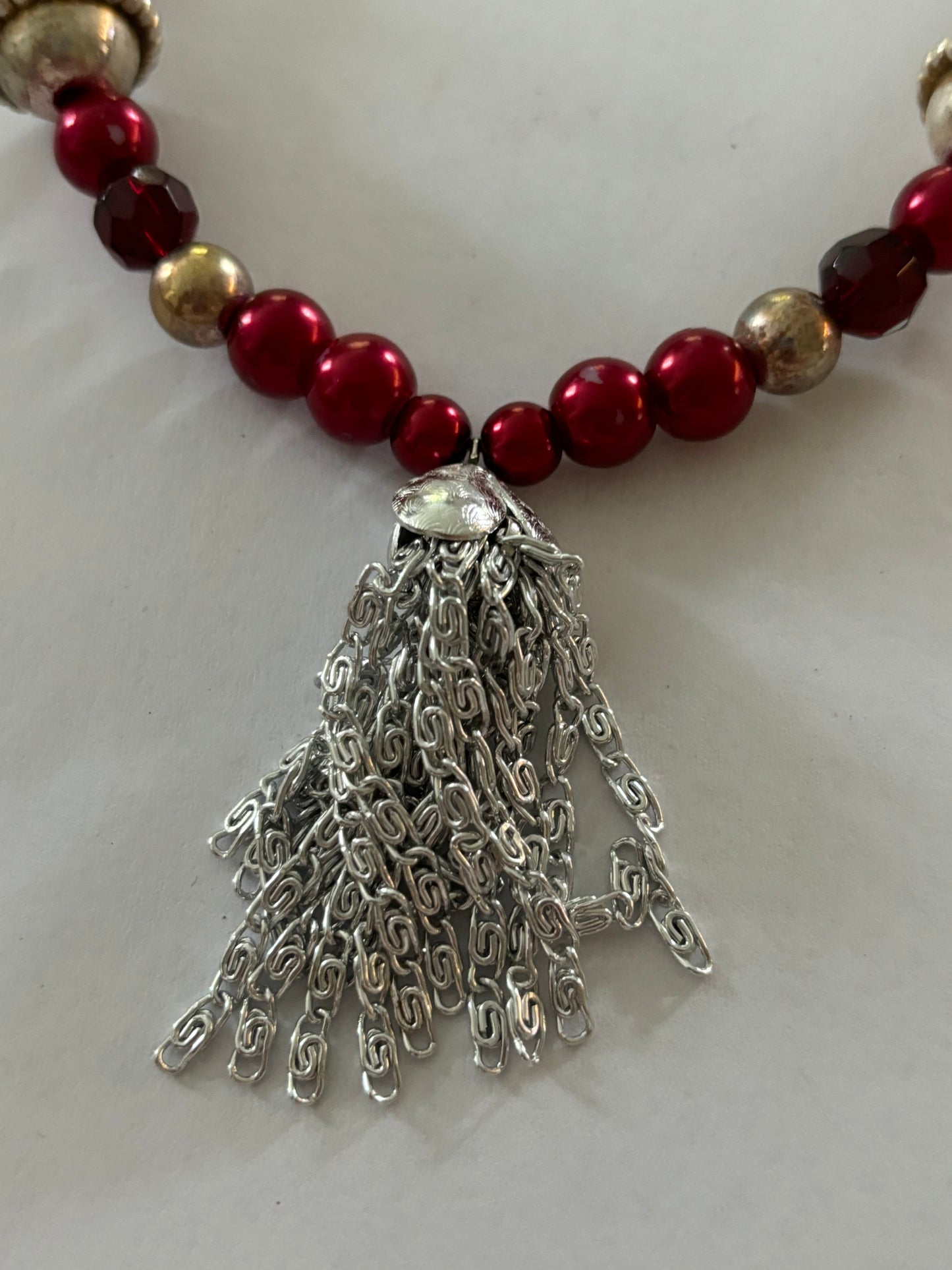 Red, gold and silver bead necklace with silver tassle