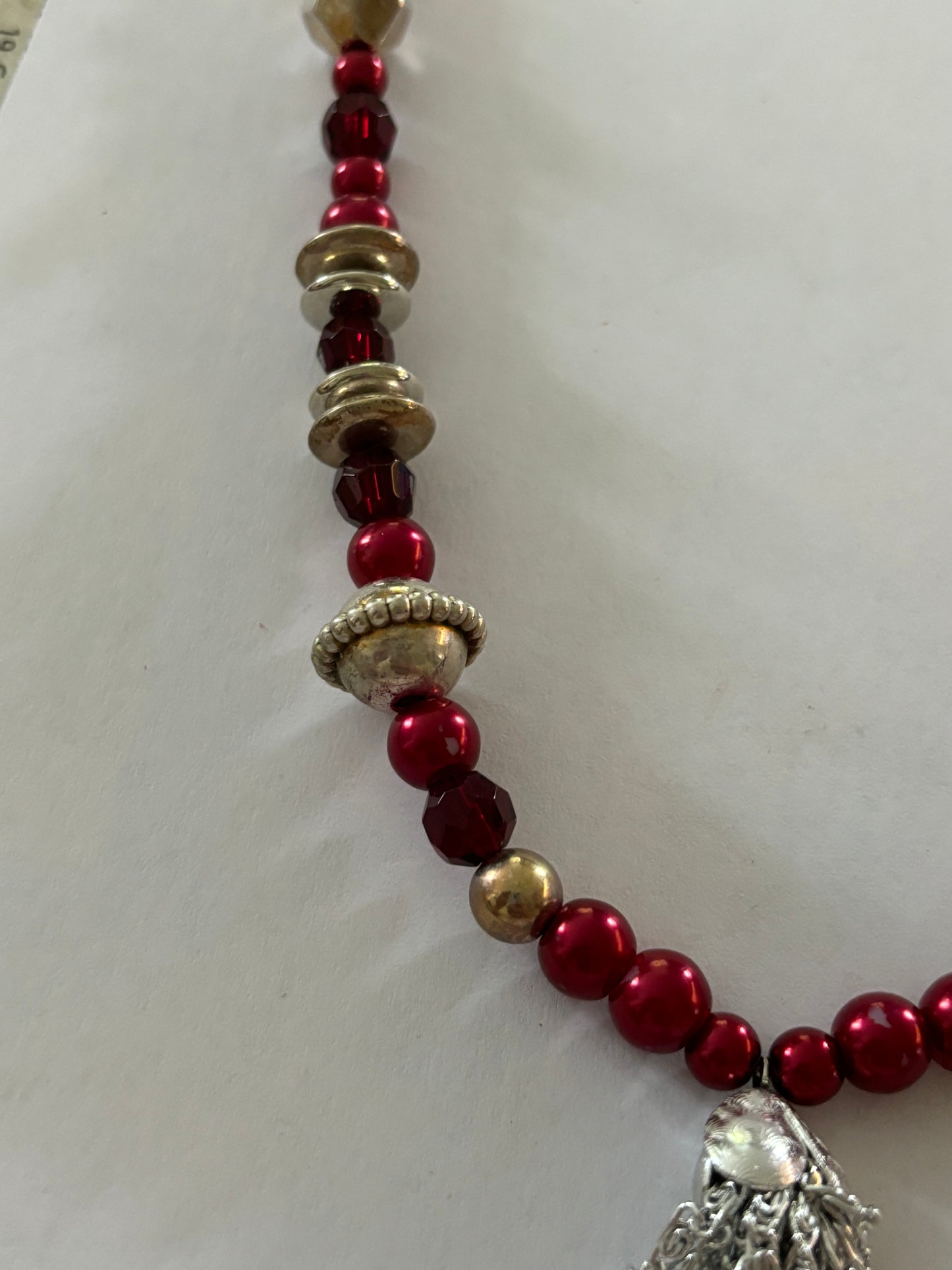 Red, gold and silver bead necklace with silver tassle