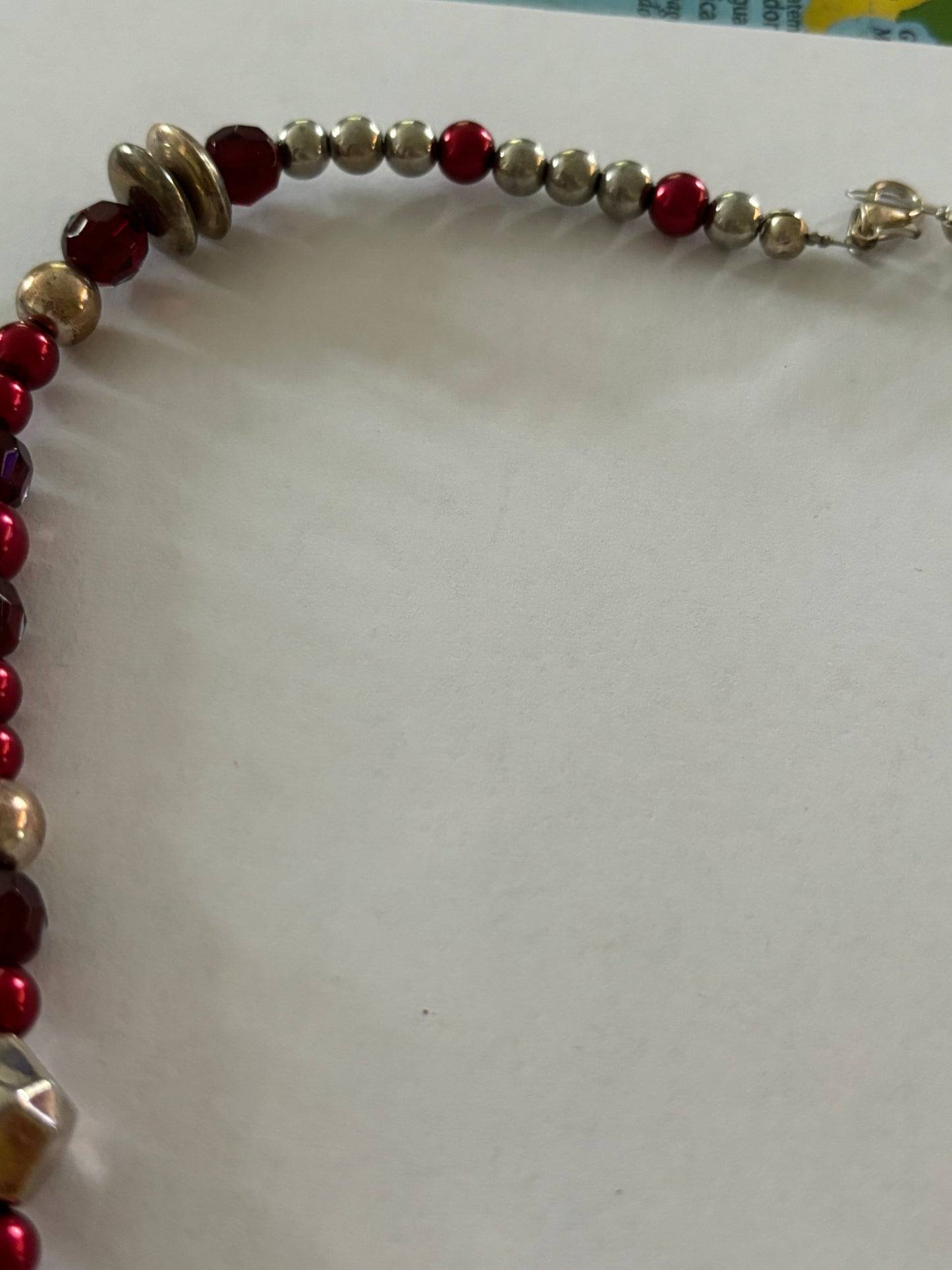 Red, gold and silver bead necklace with silver tassle