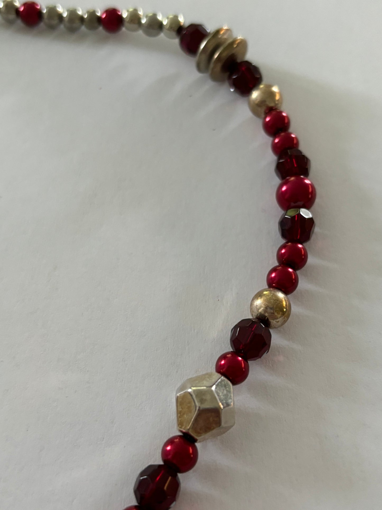 Red, gold and silver bead necklace with silver tassle