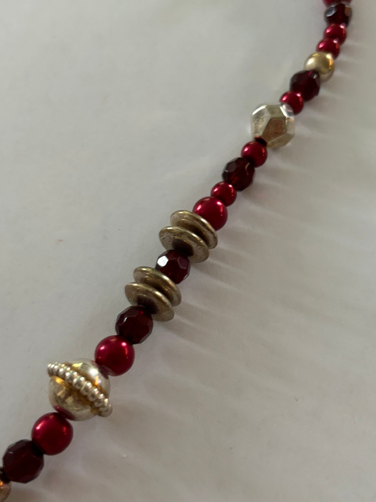 Red, gold and silver bead necklace with silver tassle