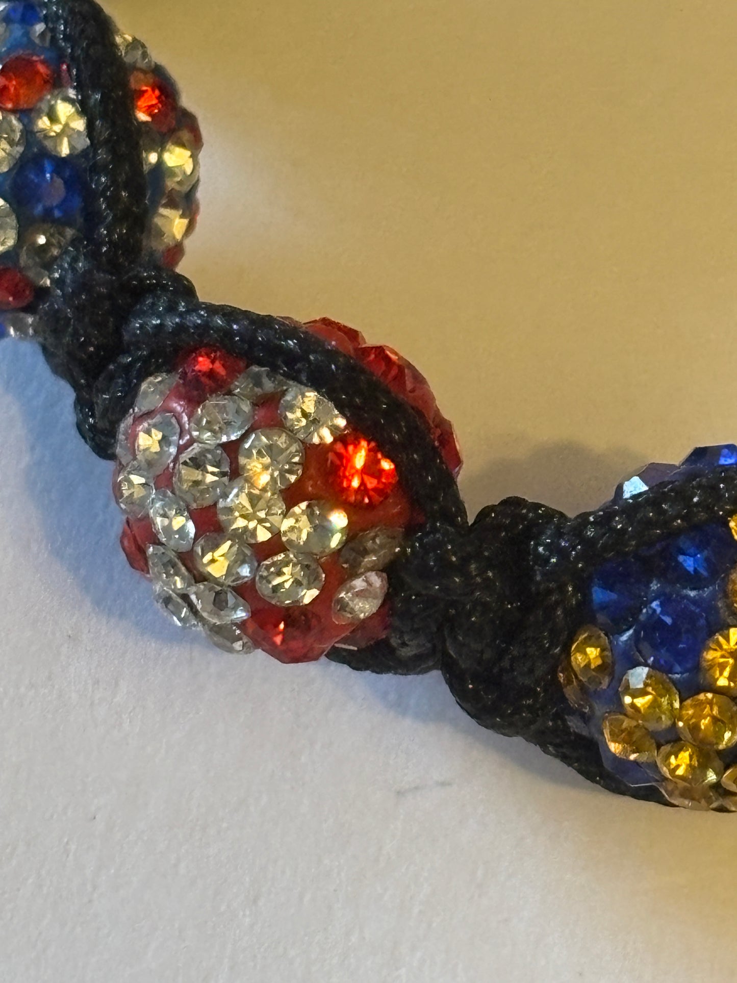 Black friendship bracelet with coloured flag crystal beads