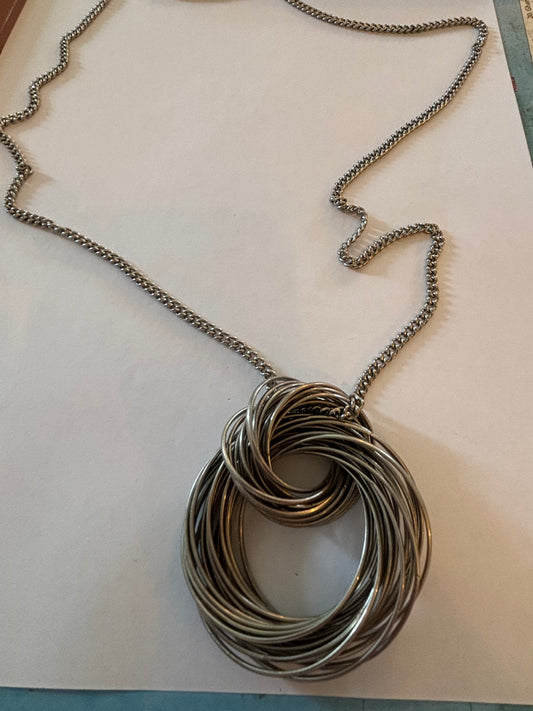 Long silver necklace with large silver multi connected rings pendant