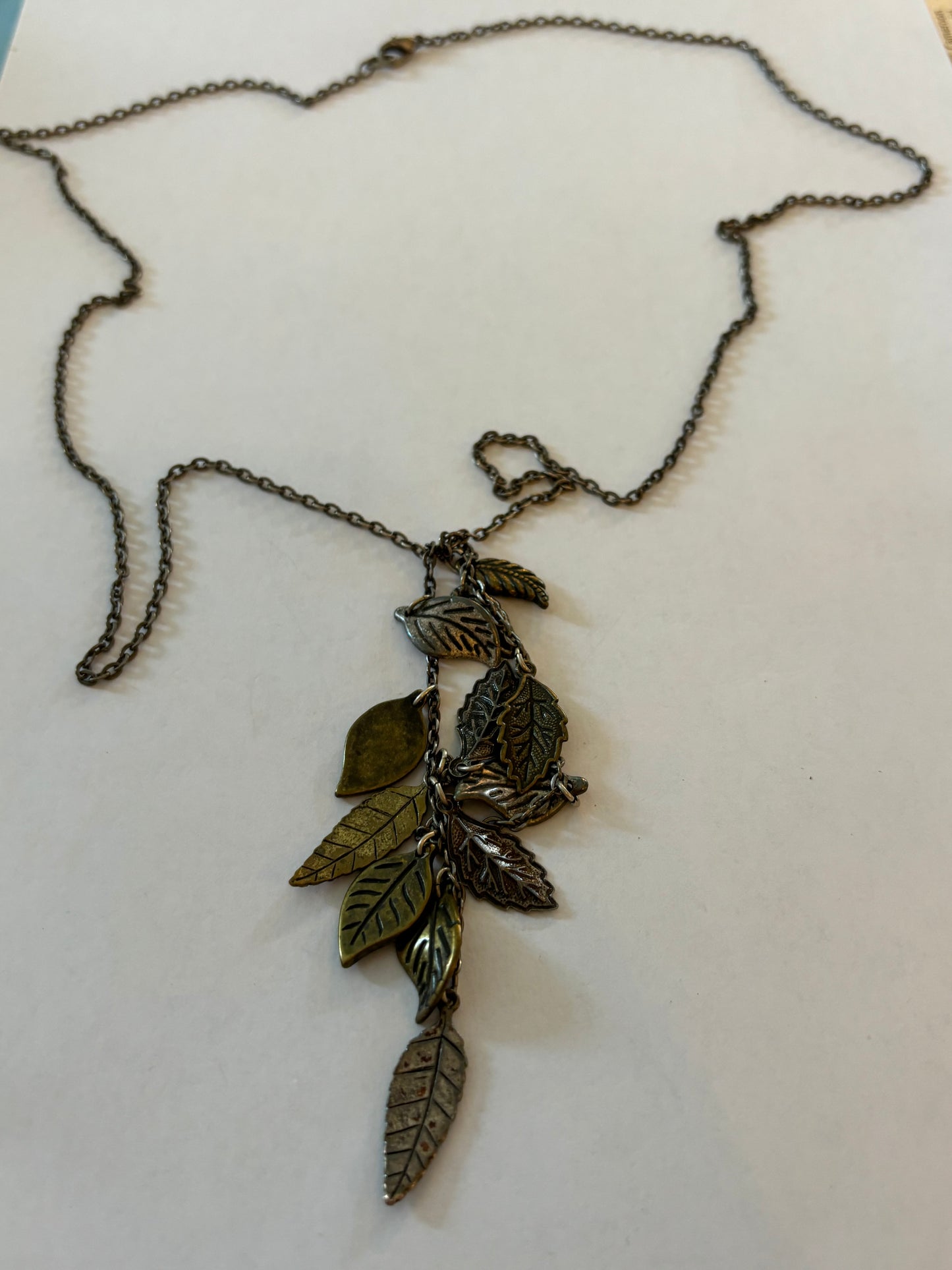 Dark metal long necklace with a drop of small leaves