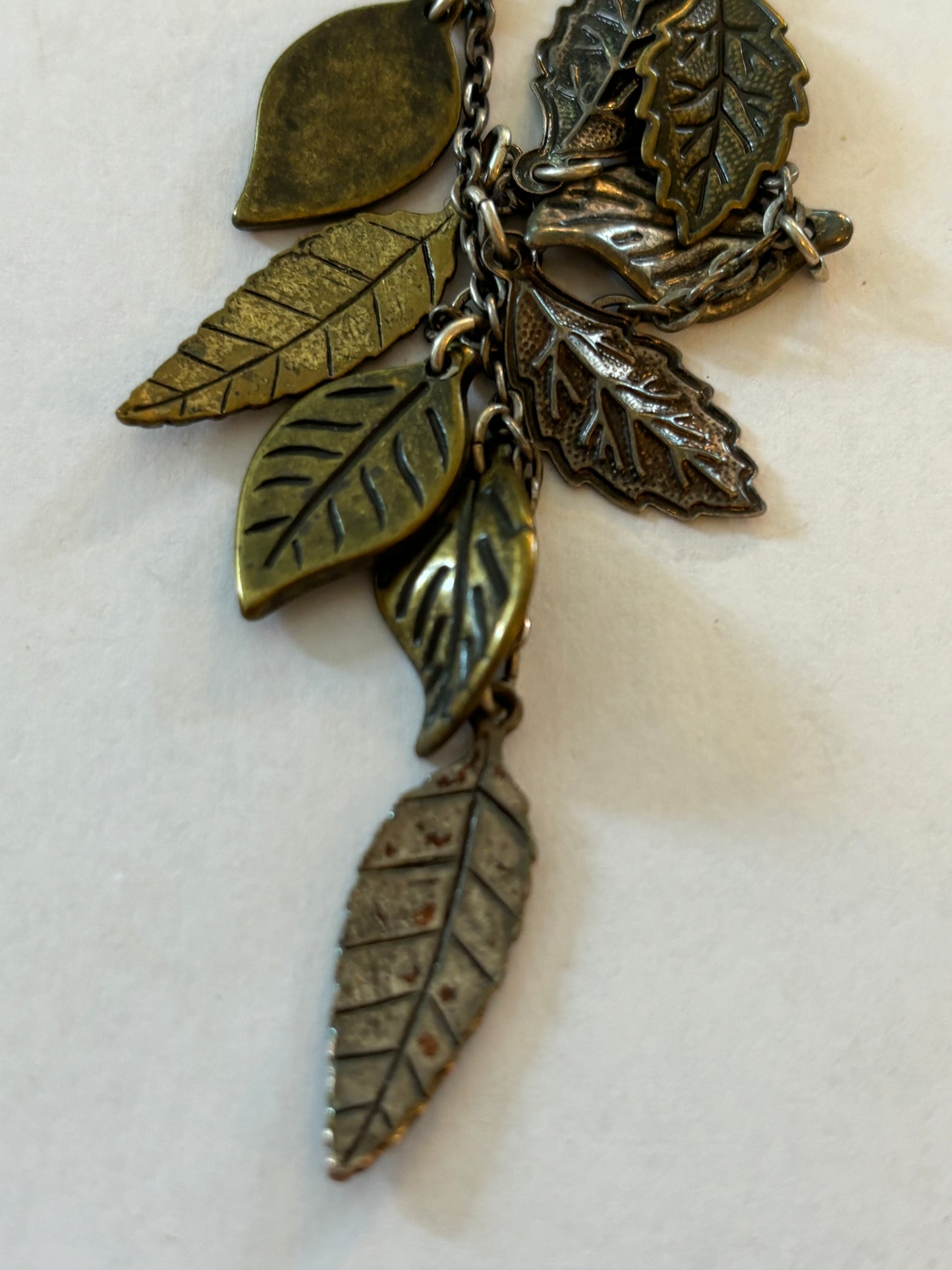 Dark metal long necklace with a drop of small leaves