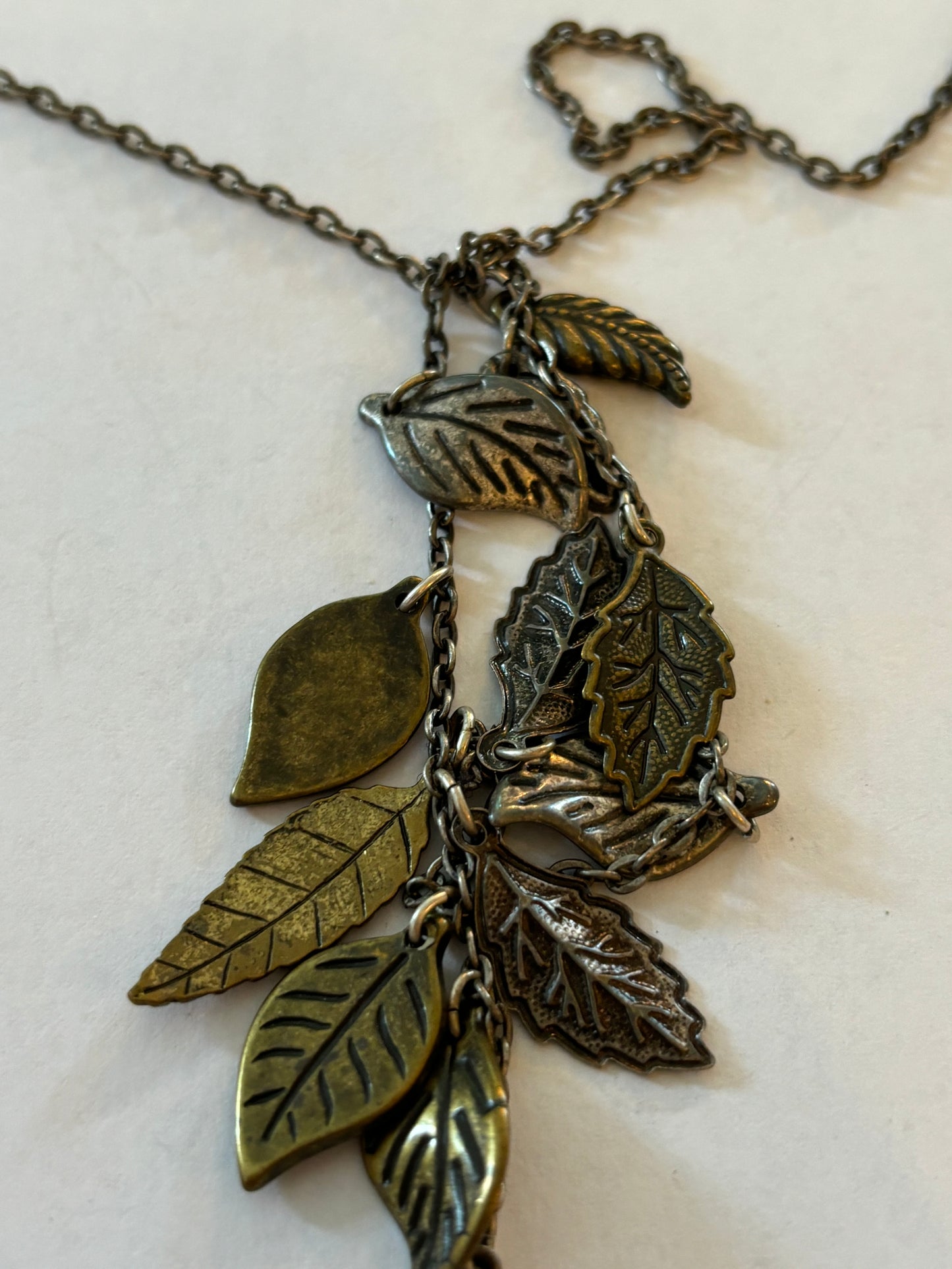 Dark metal long necklace with a drop of small leaves