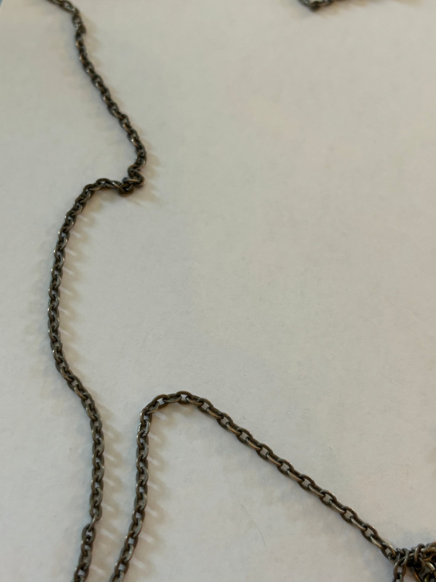 Dark metal long necklace with a drop of small leaves