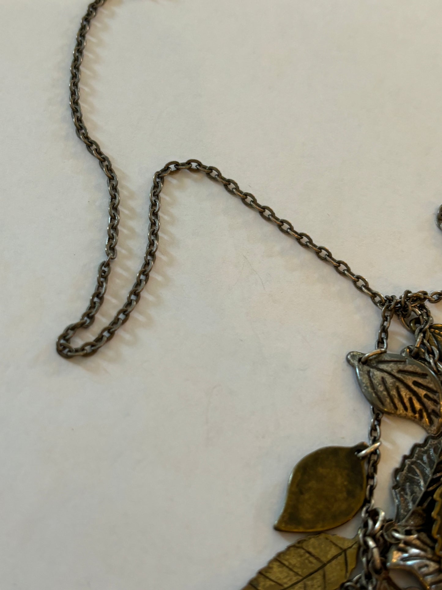 Dark metal long necklace with a drop of small leaves