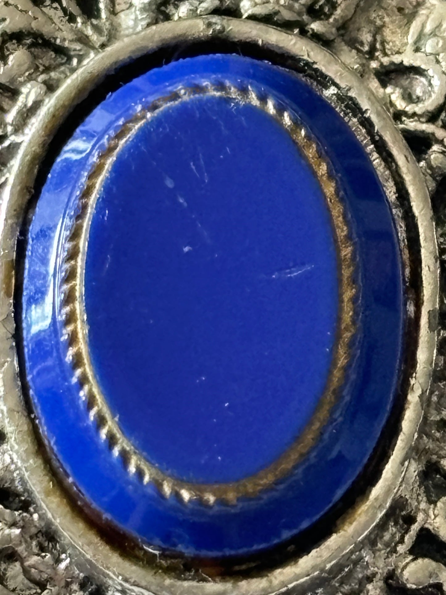 Round silver metal ornate scarf clip with oval blue centre