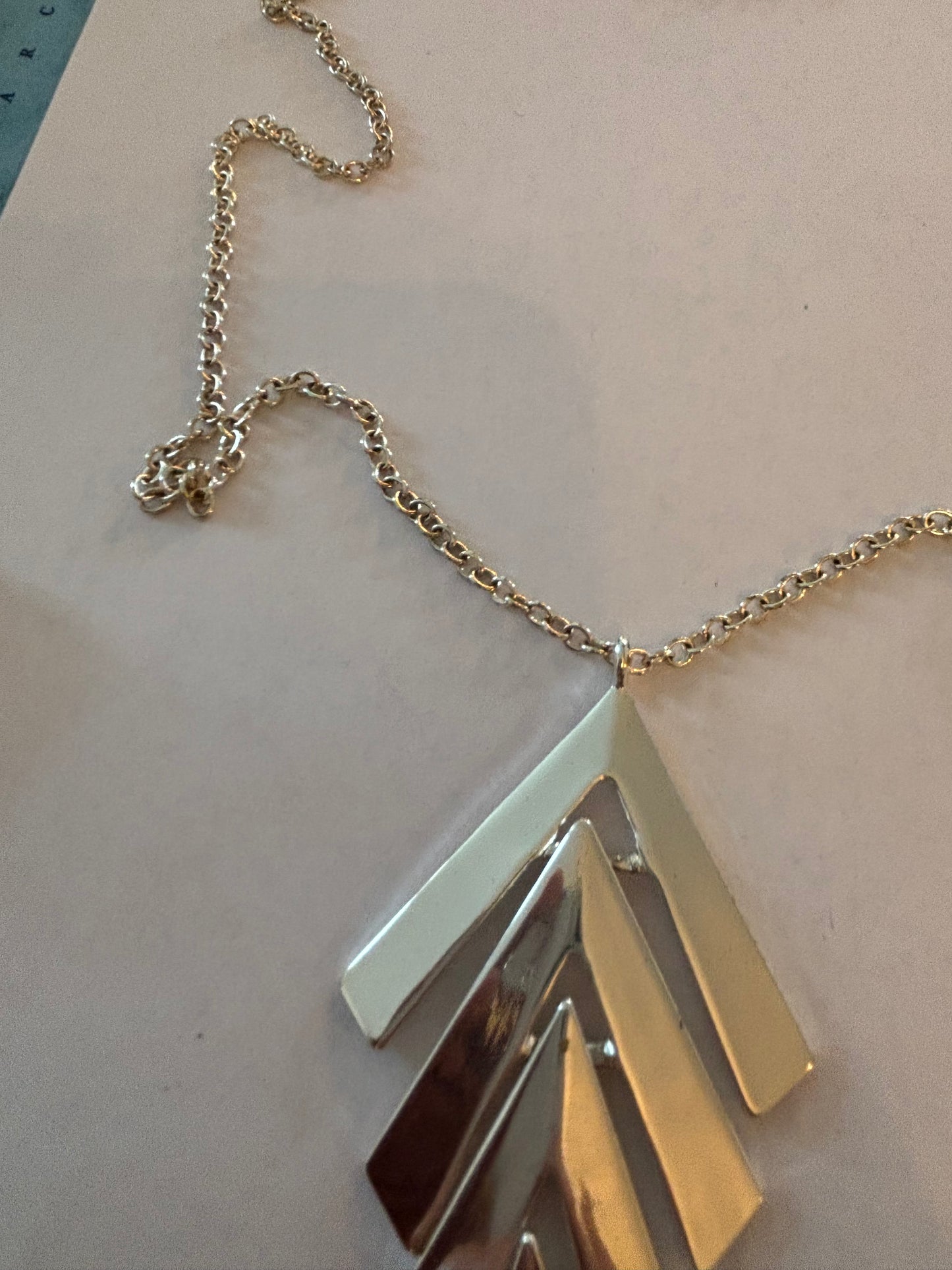 Long silver necklace with chevrons pendant