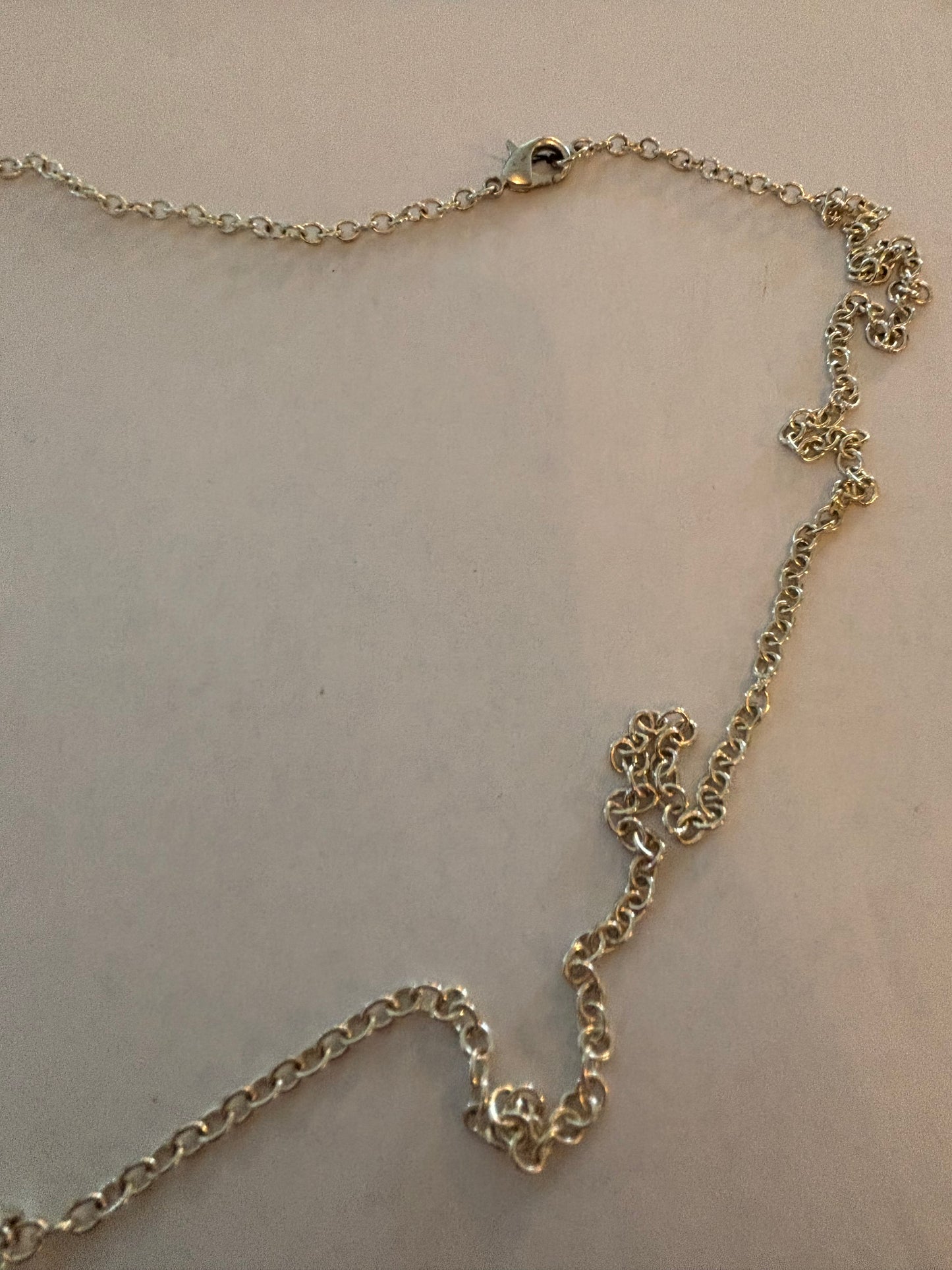 Long silver necklace with chevrons pendant