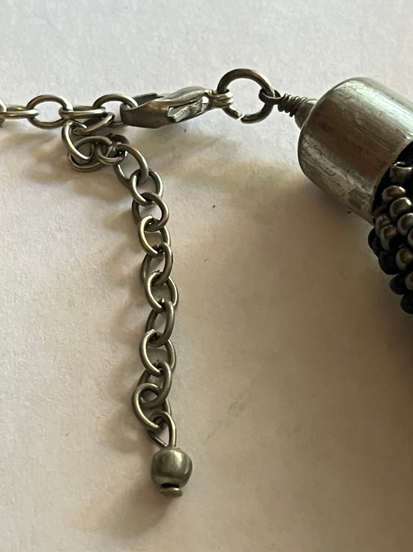 Large beaded stiff tube necklace with black and silver beads and sequins