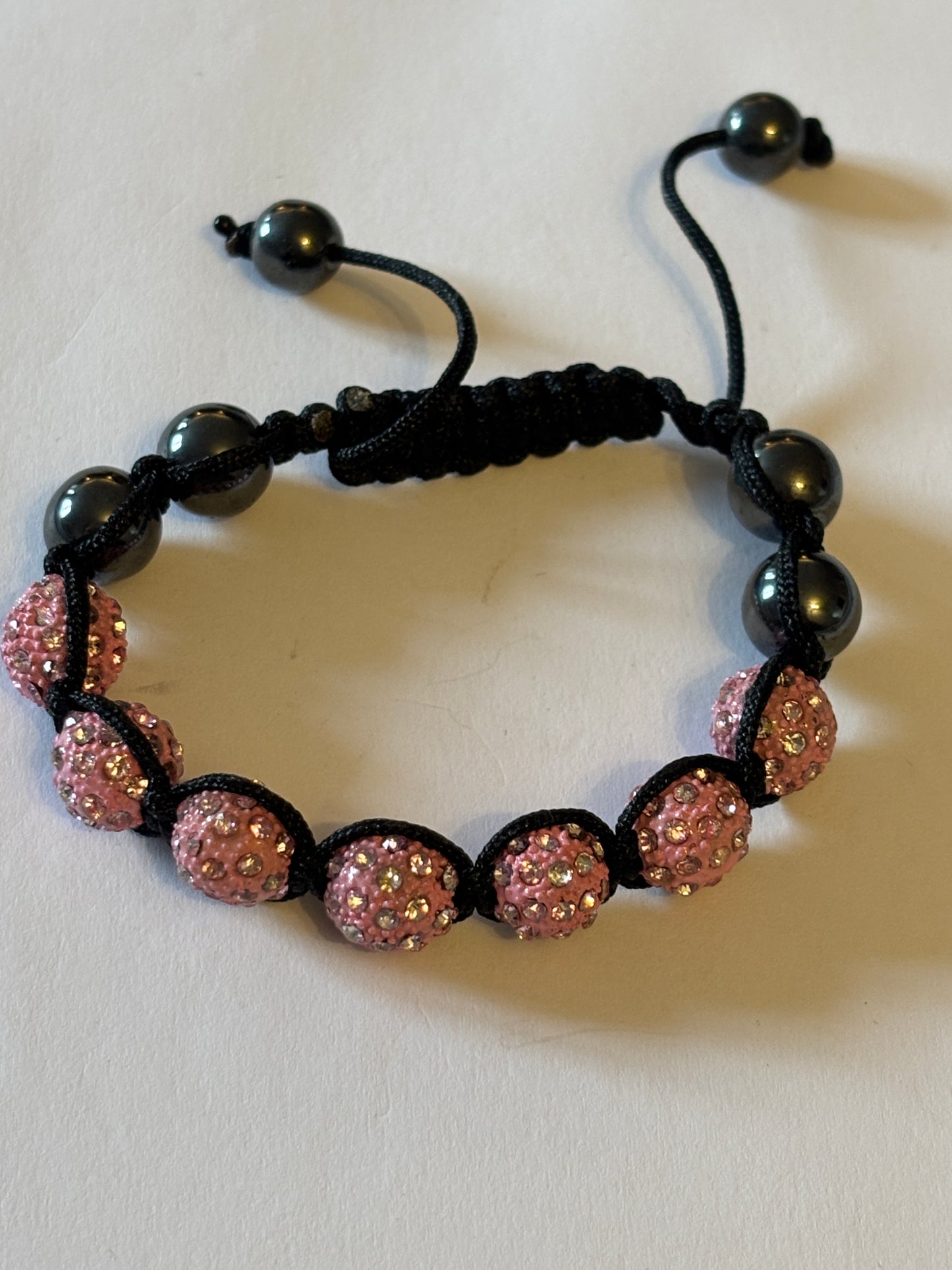 Black friendship bracelet with graphite and sparkly pink beads