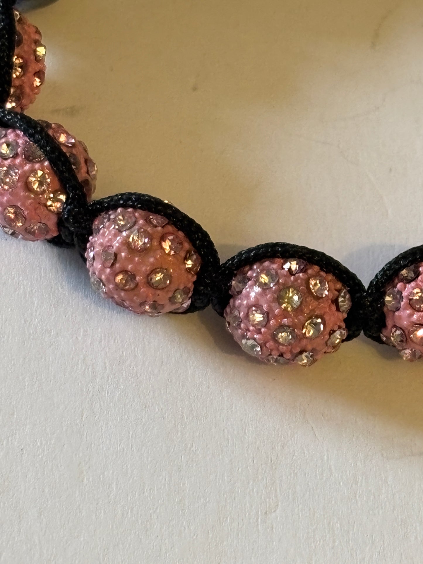 Black friendship bracelet with graphite and sparkly pink beads