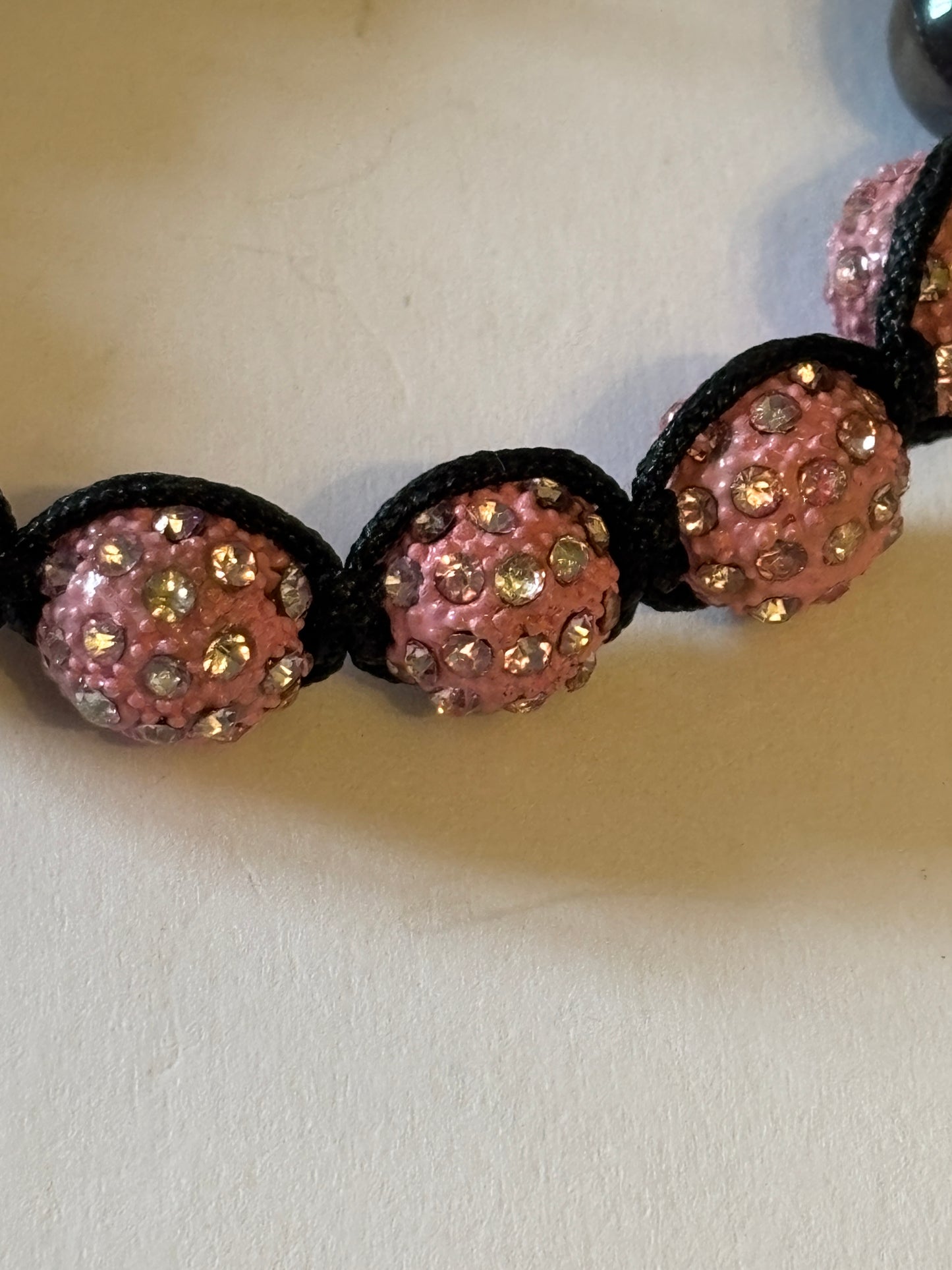 Black friendship bracelet with graphite and sparkly pink beads