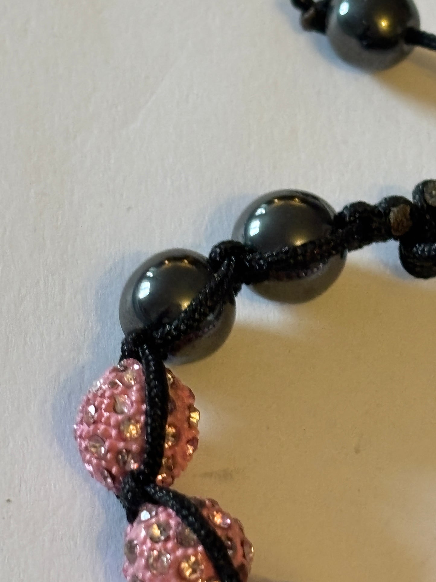 Black friendship bracelet with graphite and sparkly pink beads