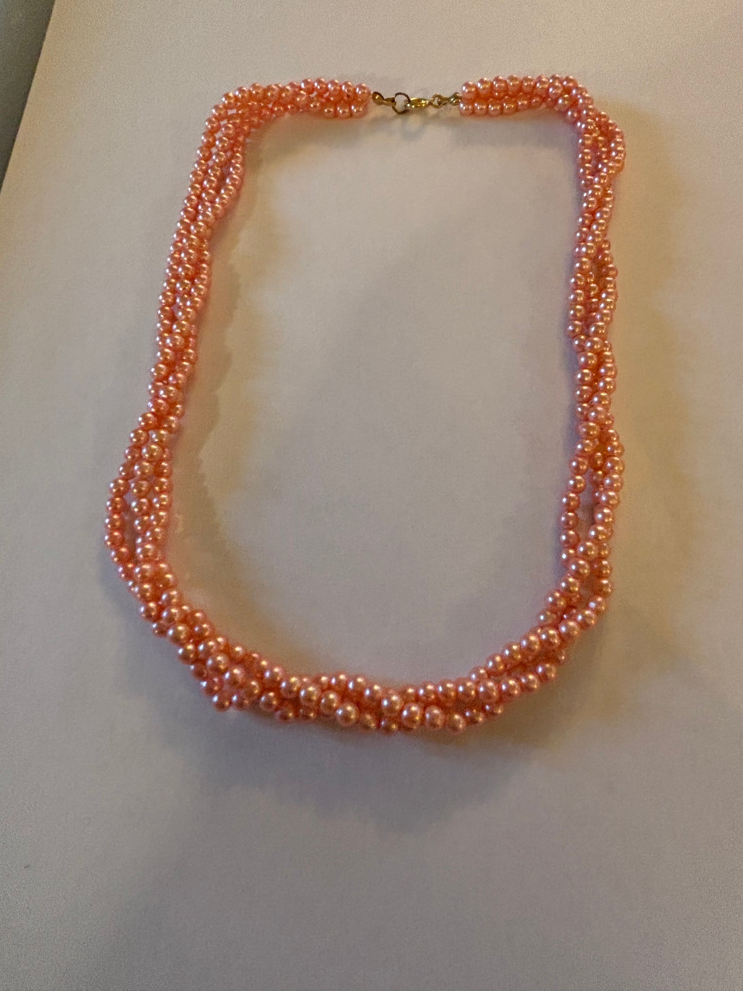 Triple strand bright pearlescent small pink bead necklace