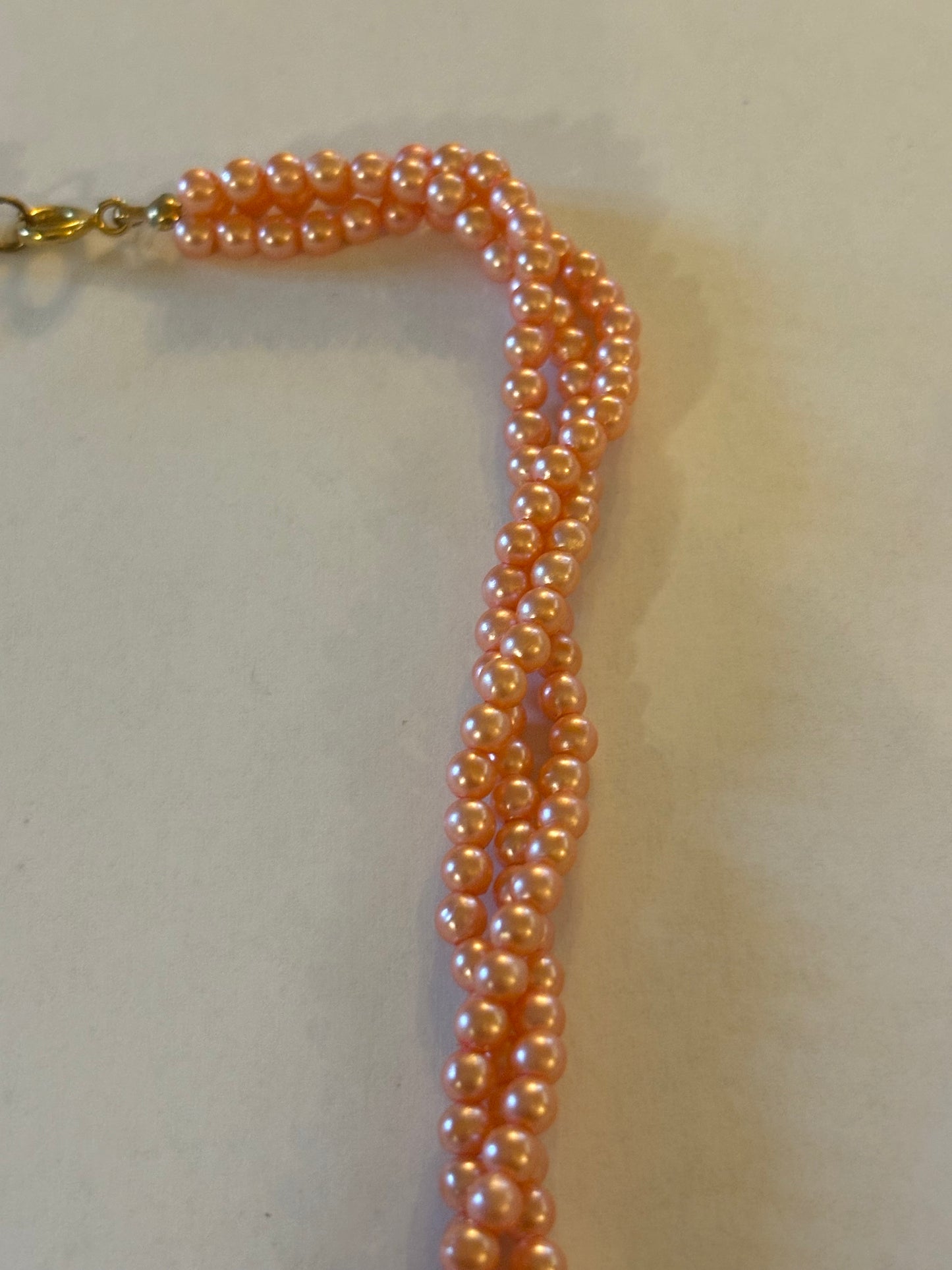 Triple strand bright pearlescent small pink bead necklace