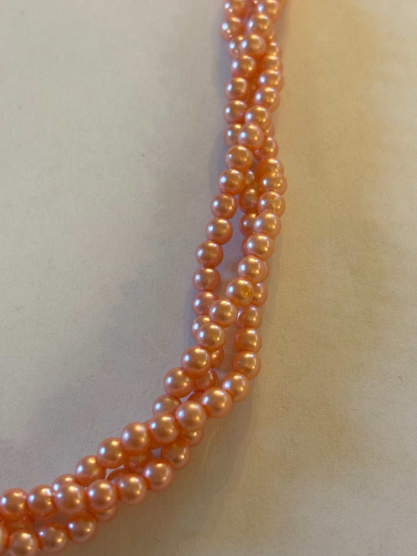 Triple strand bright pearlescent small pink bead necklace