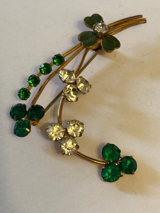 Gold flower spray brooch with vivid green and white stones