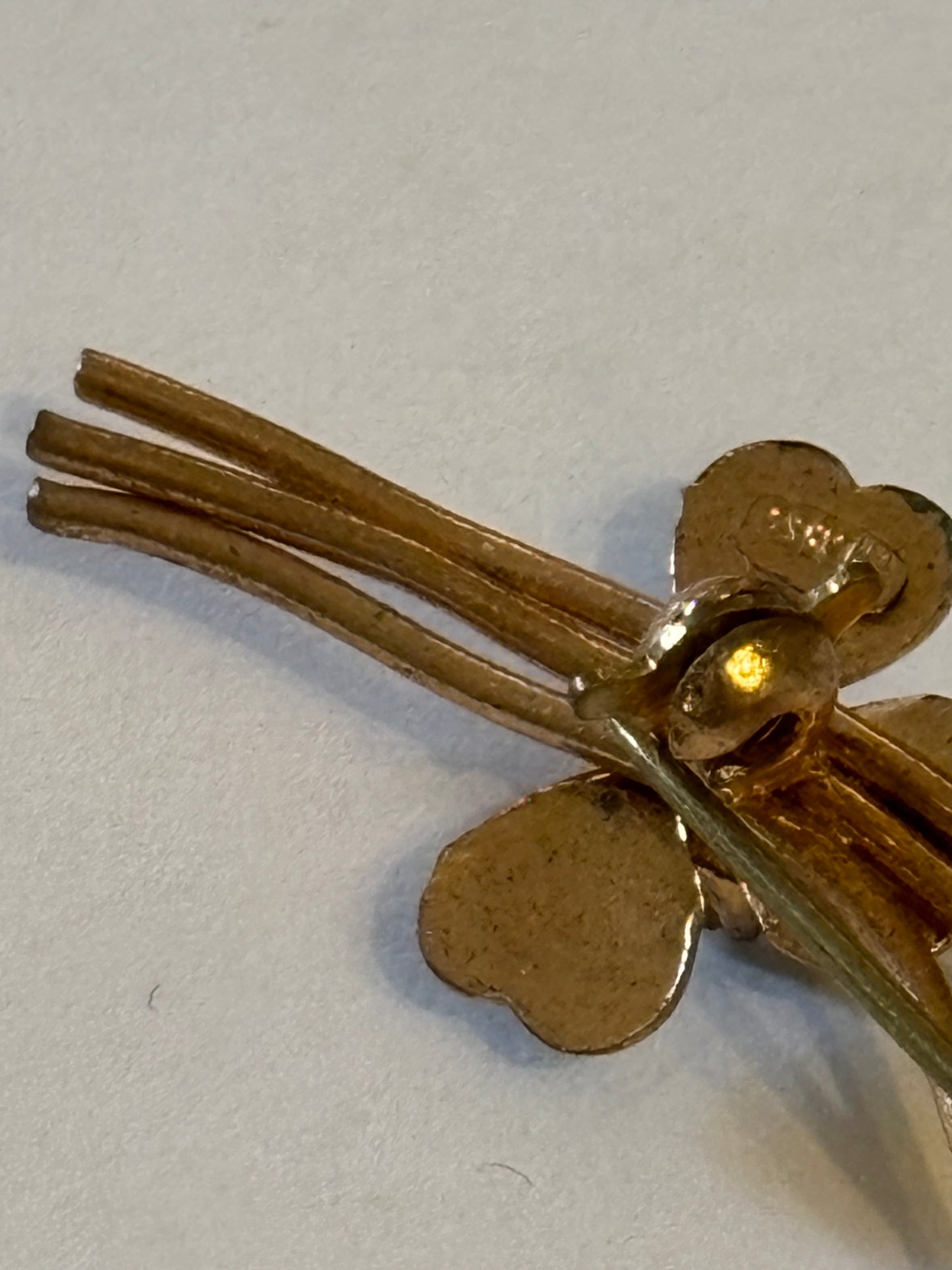 Gold flower spray brooch with vivid green and white stones