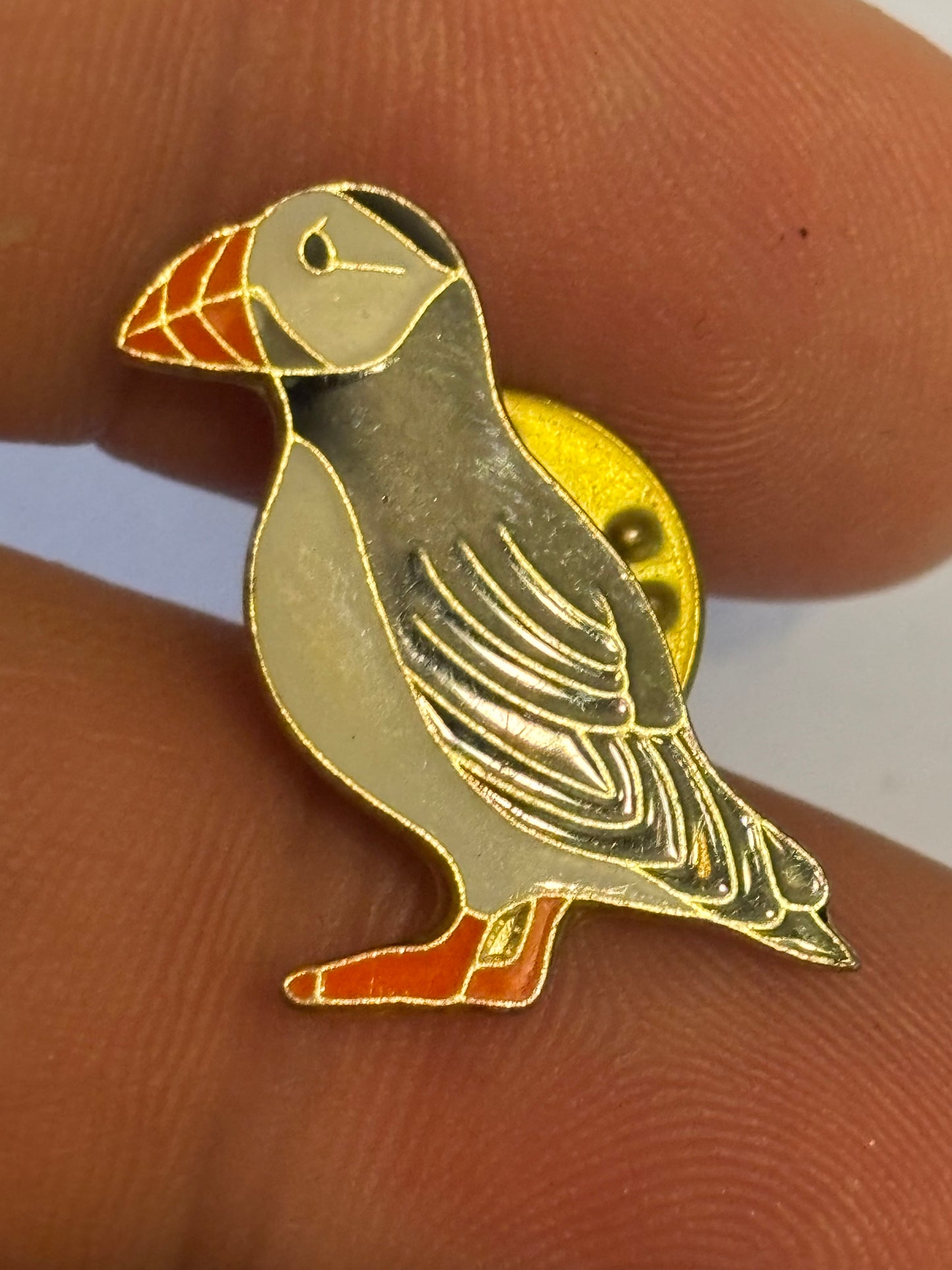 Small metal and coloured puffin badge