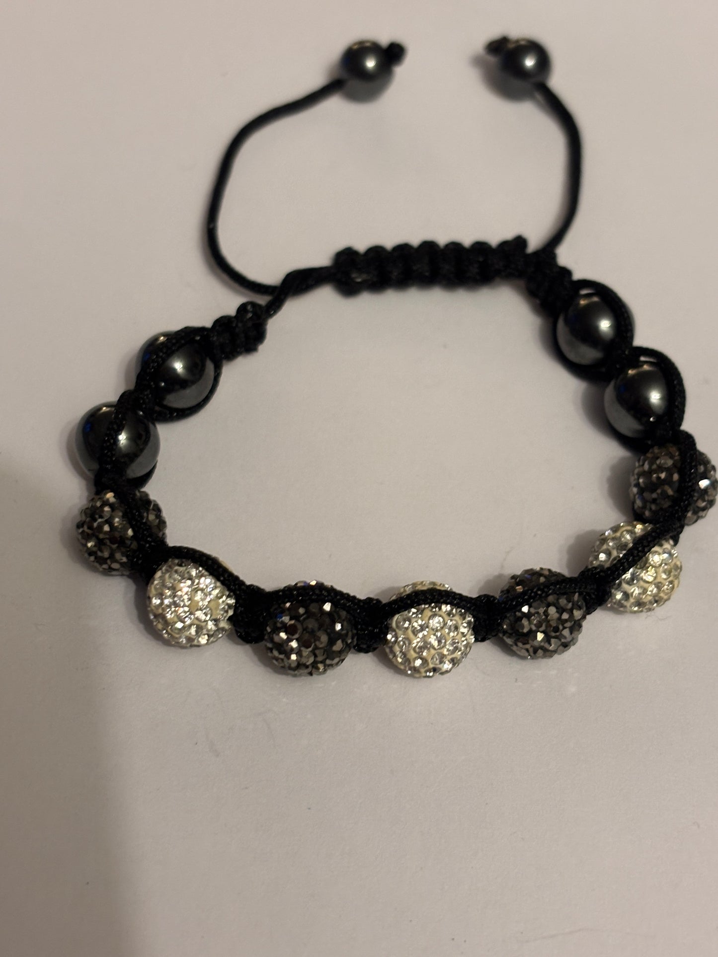 Black string friendship bracelet with silver and grey crystal beads