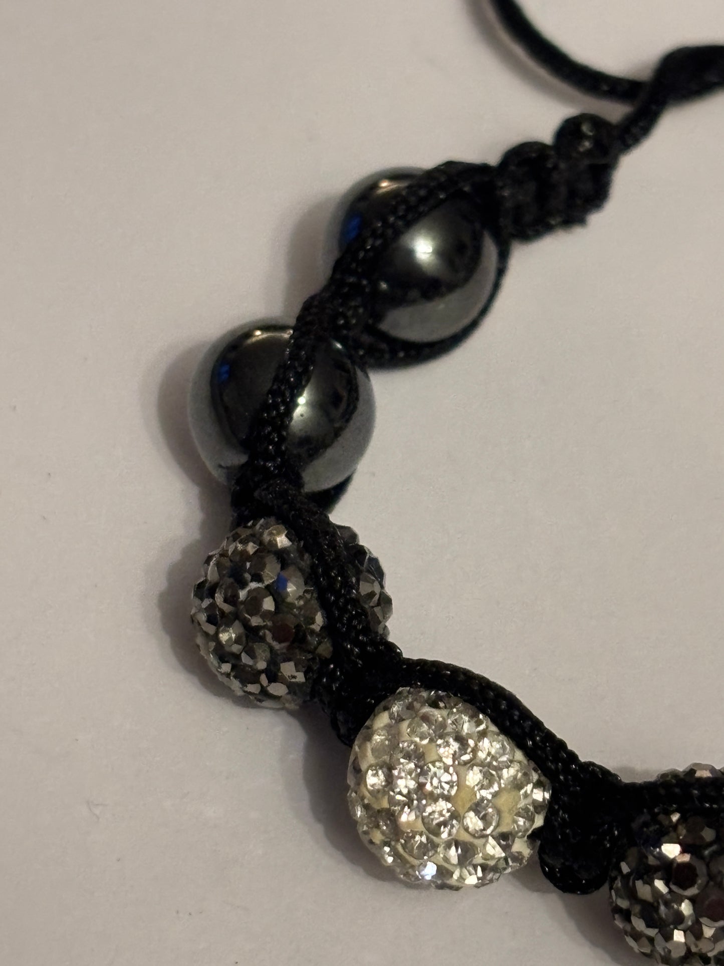 Black string friendship bracelet with silver and grey crystal beads