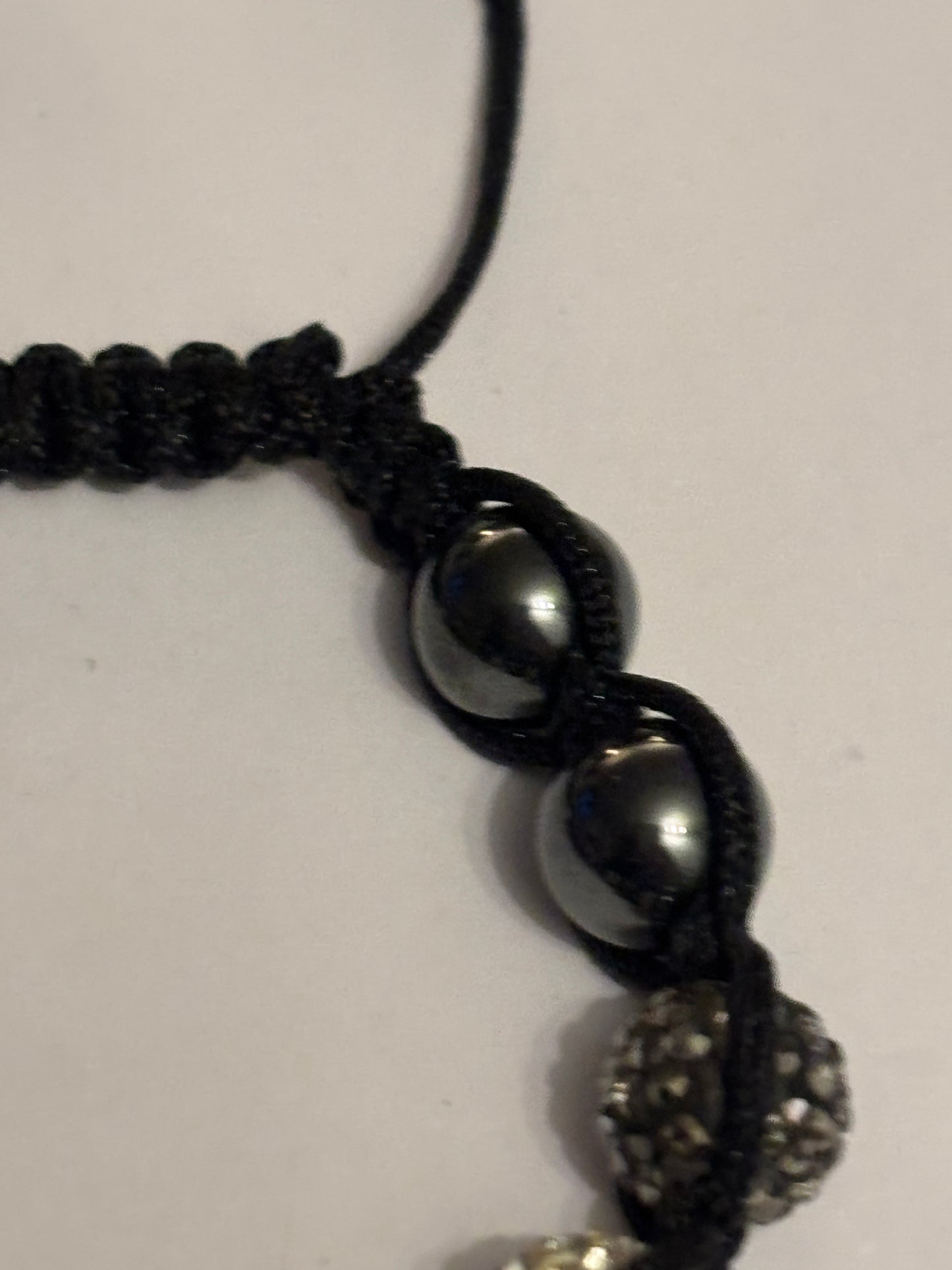 Black string friendship bracelet with silver and grey crystal beads