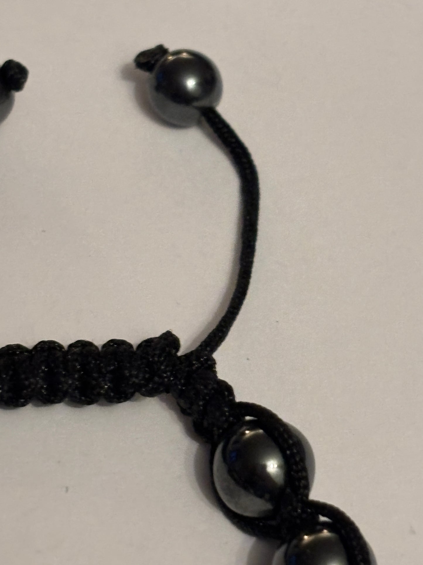 Black string friendship bracelet with silver and grey crystal beads