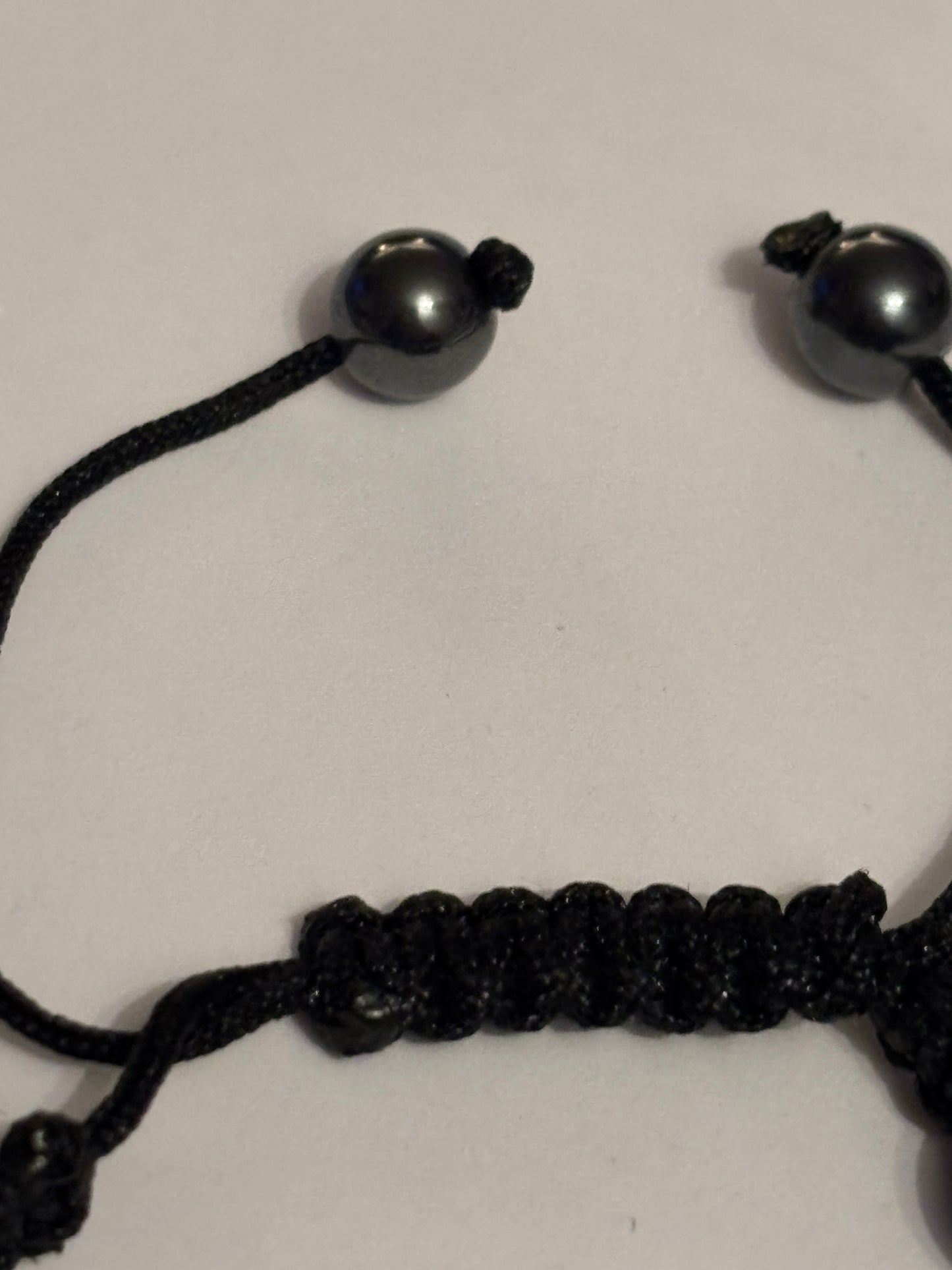 Black string friendship bracelet with silver and grey crystal beads