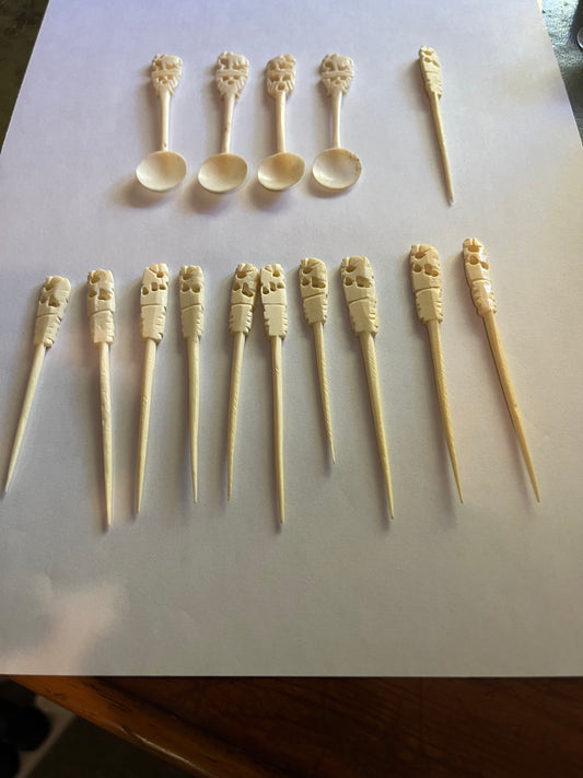 Set of small cream coloured elephant pattern cocktail sticks and spoons