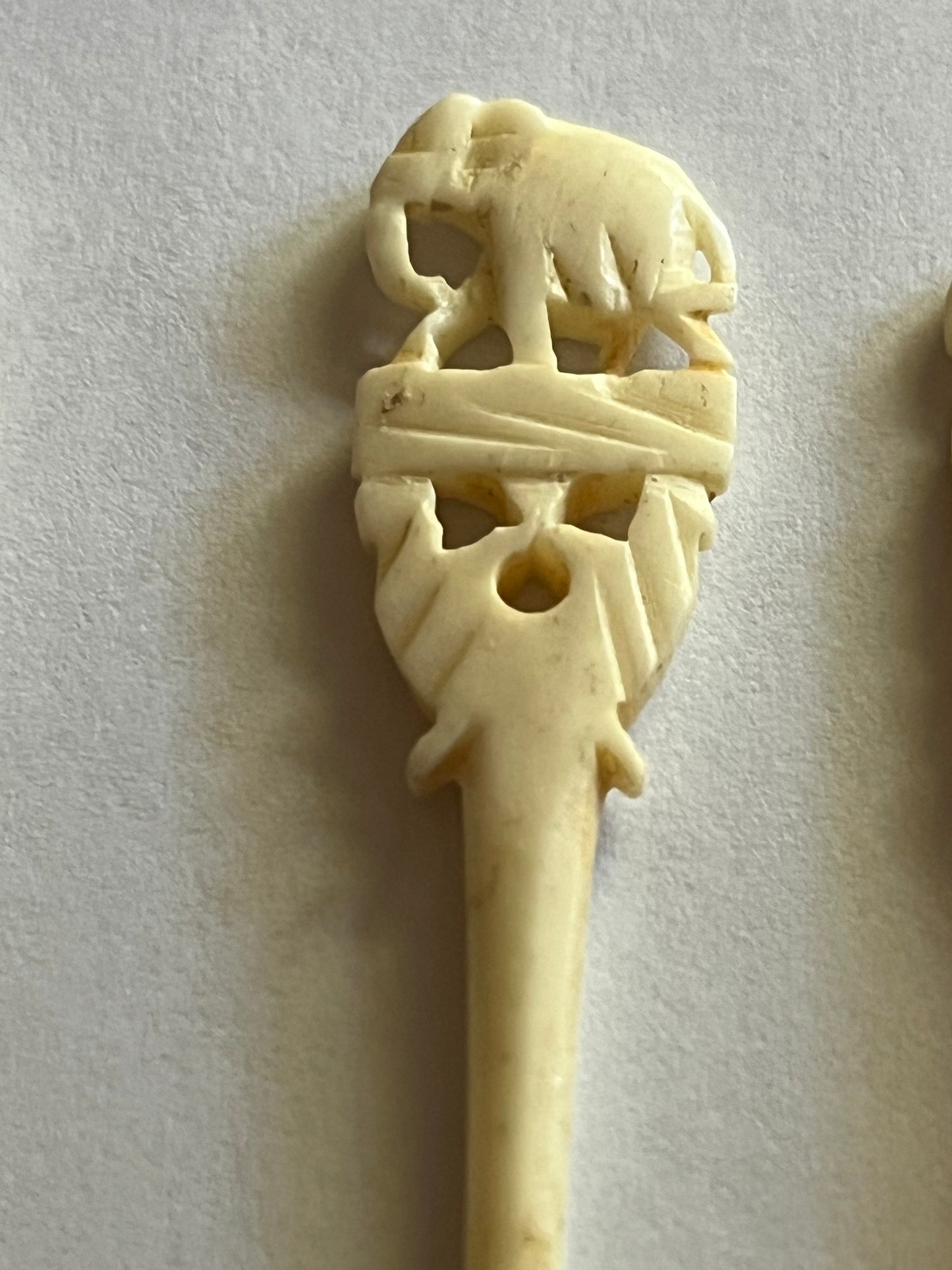 Set of small cream coloured elephant pattern cocktail sticks and spoons