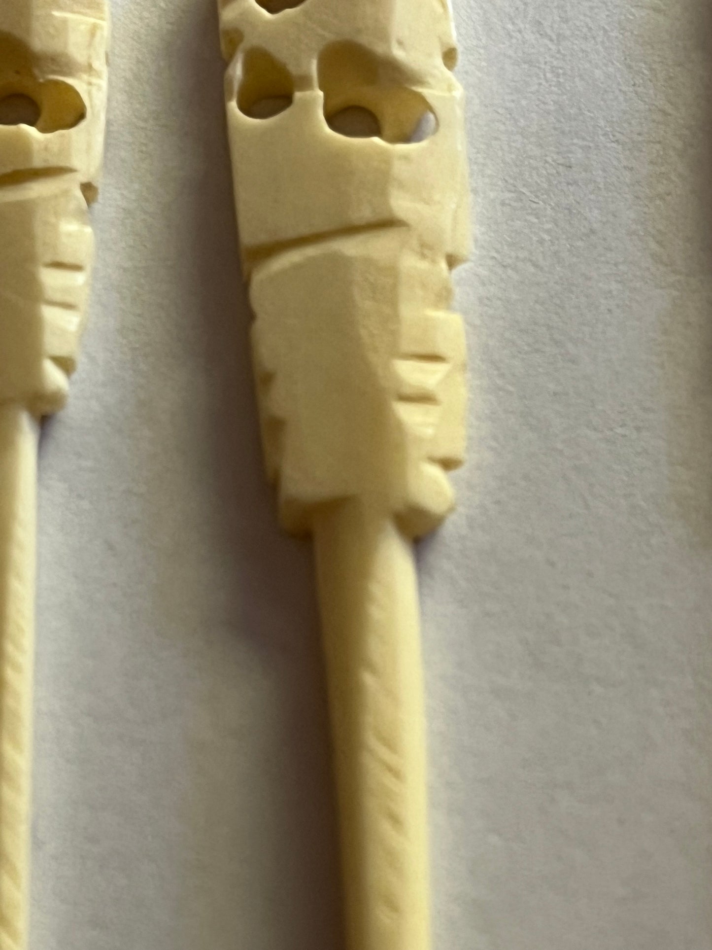 Set of small cream coloured elephant pattern cocktail sticks and spoons