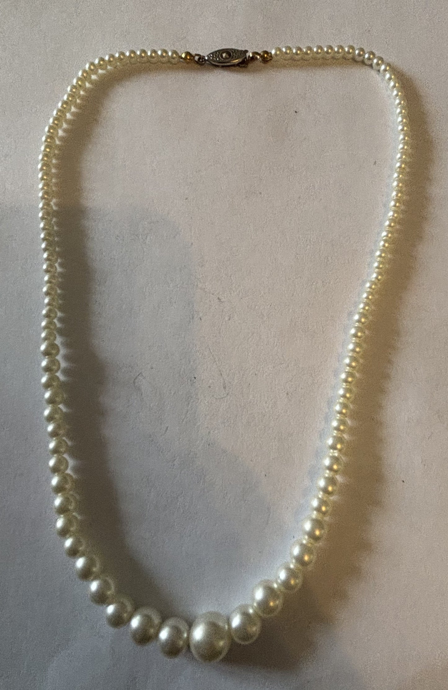 Slightly graduated pearl style necklace