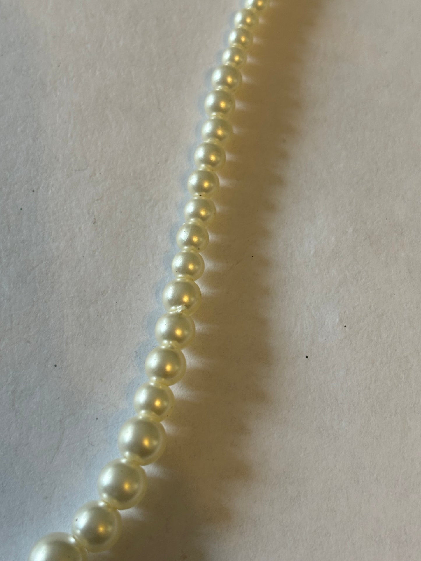 Slightly graduated pearl style necklace