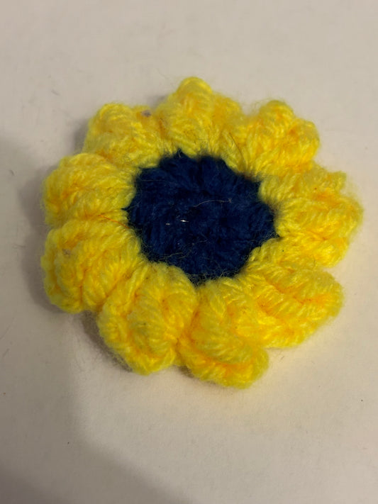 Yellow and dark blue crochet flower brooch