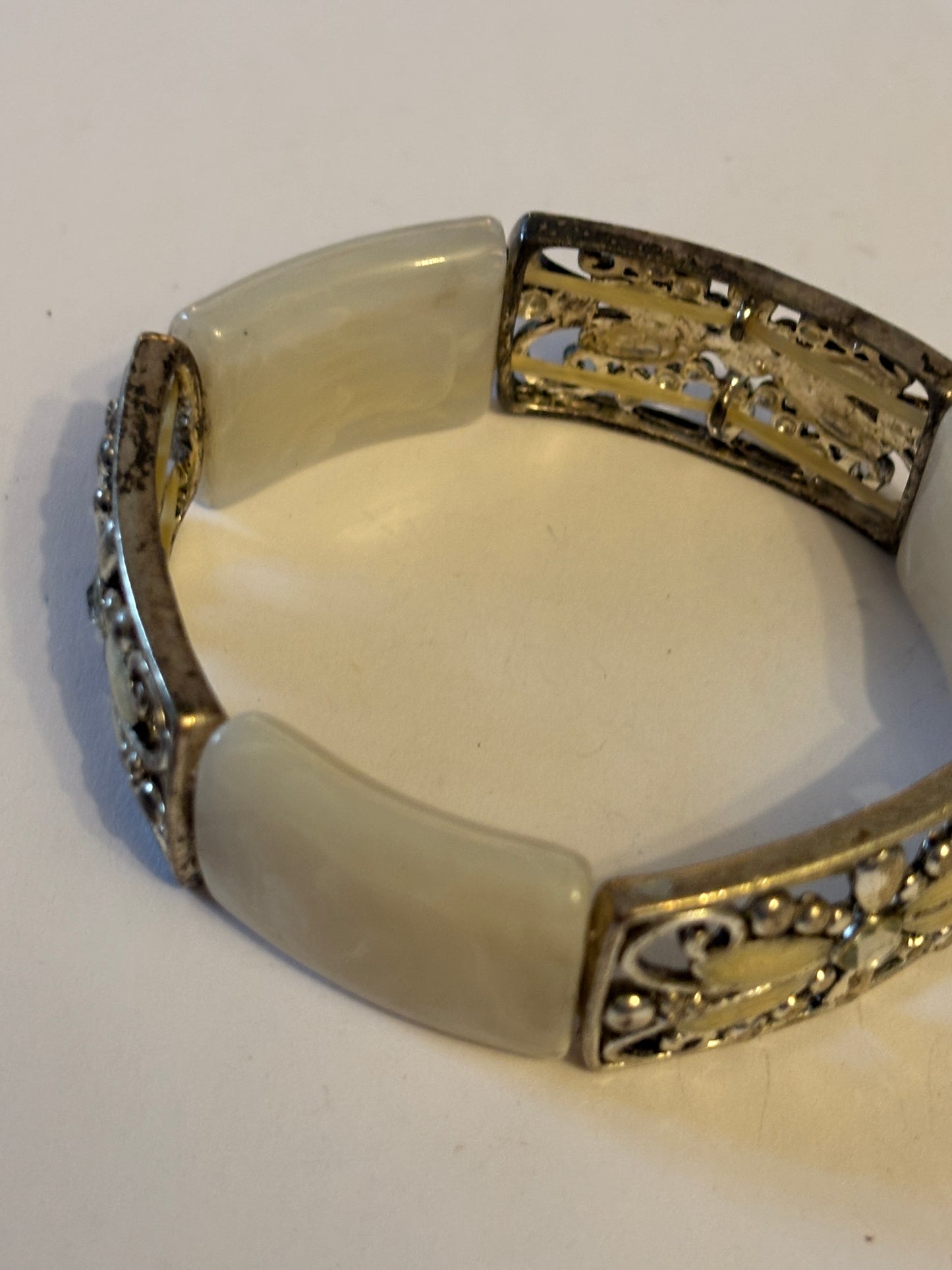 White swirl pattern and ornate silver panel bracelet