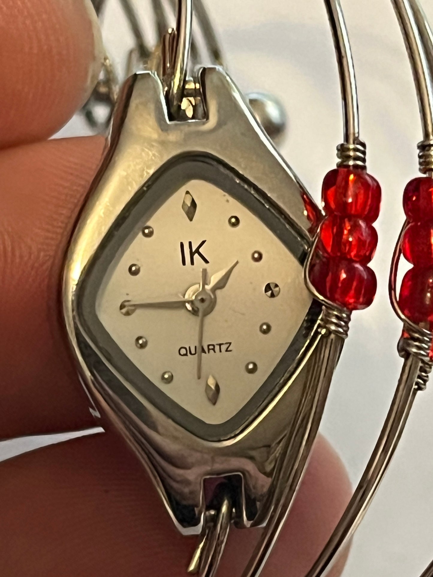 Unusual multi wire bangle with read beads and a watch