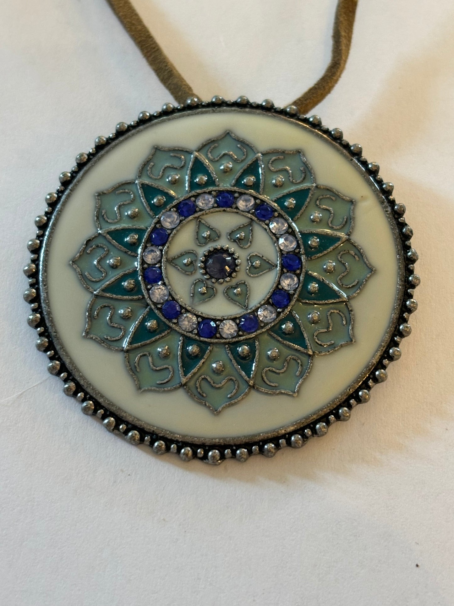 Light brown leather necklace with large round blue and white enamel pendant