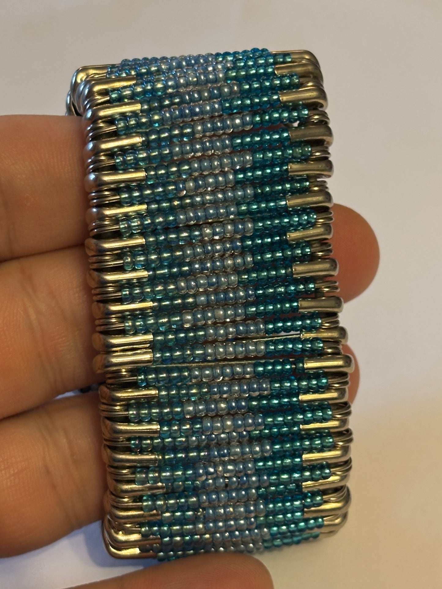 Wide stretch bracelet with rows of tiny blue beads capped with silver