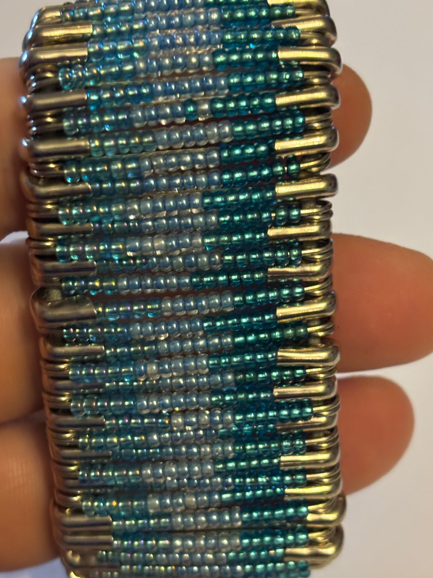 Wide stretch bracelet with rows of tiny blue beads capped with silver