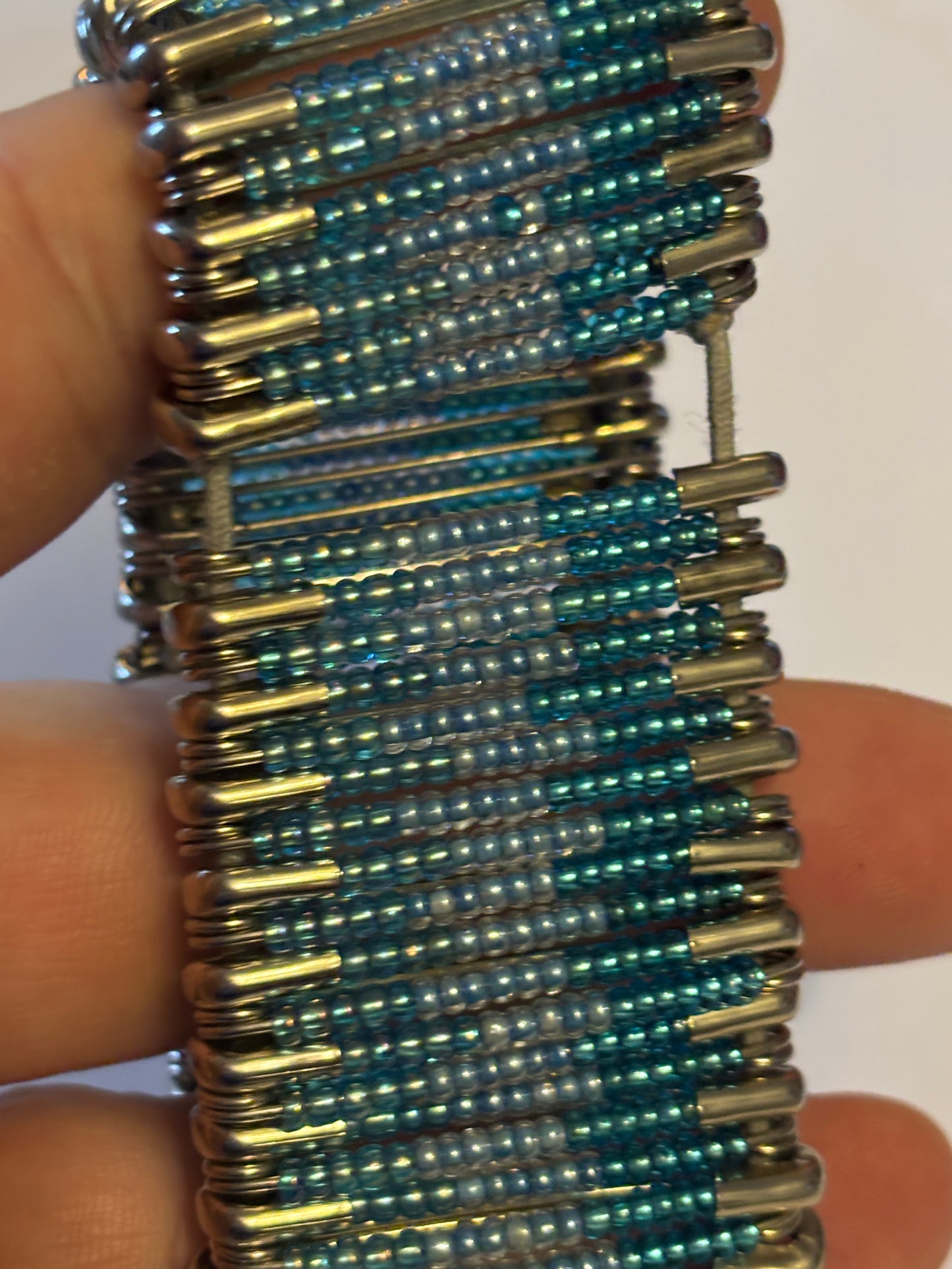 Wide stretch bracelet with rows of tiny blue beads capped with silver