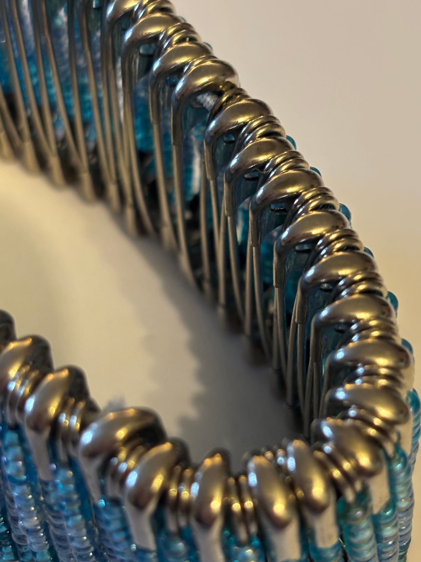 Wide stretch bracelet with rows of tiny blue beads capped with silver