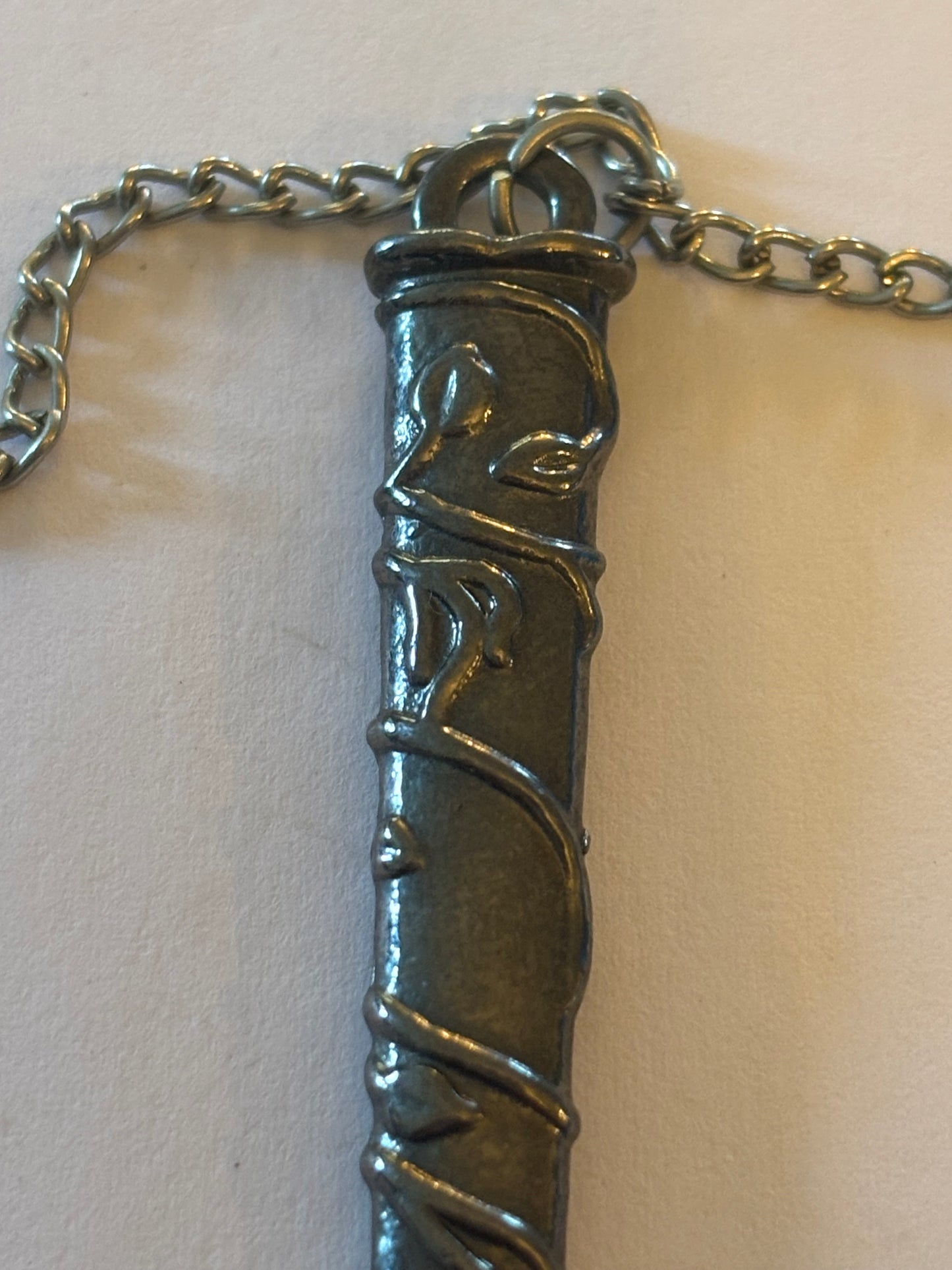 Long silver chain necklace with long sword sheath pendant