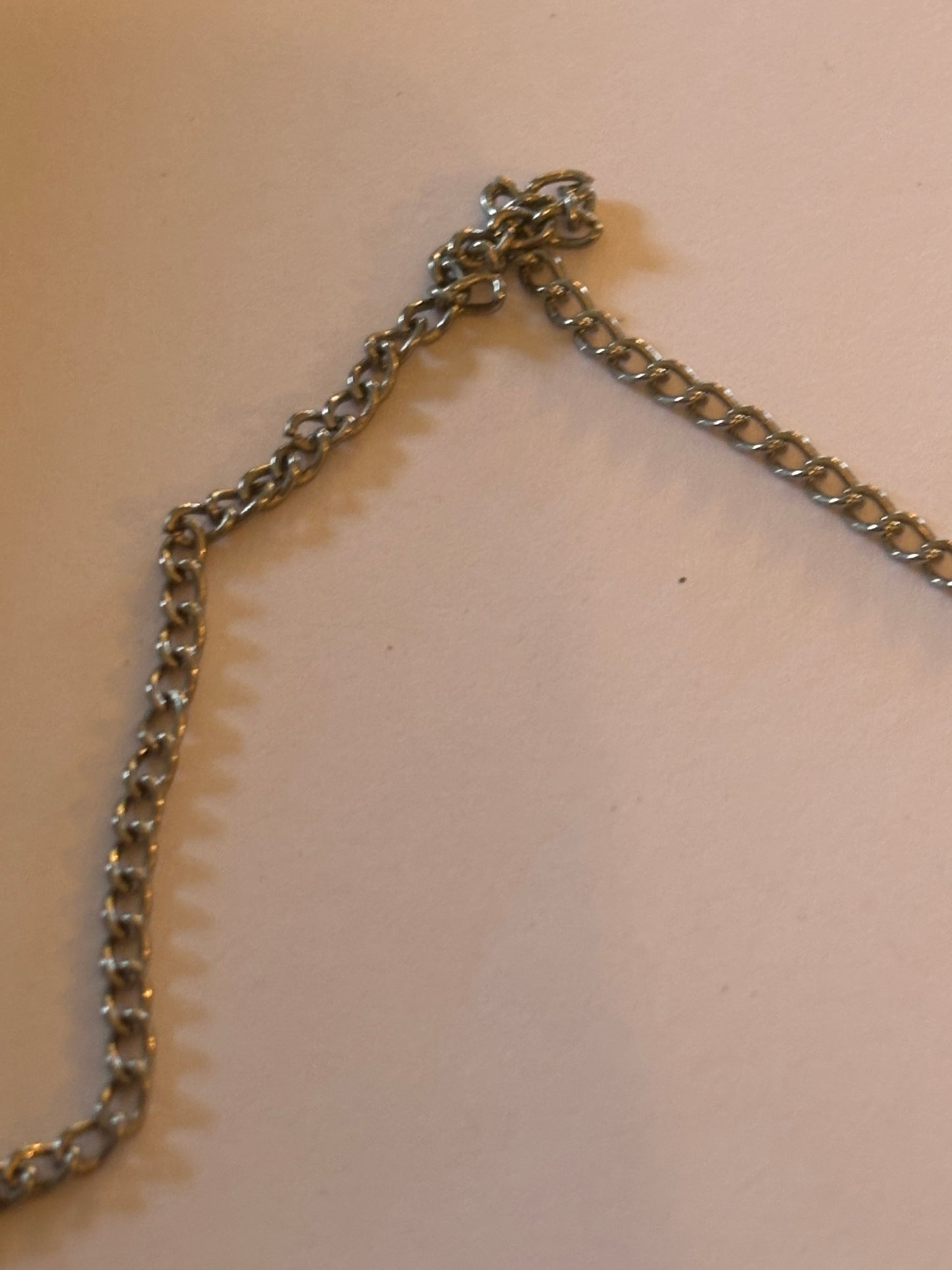 Long silver chain necklace with long sword sheath pendant