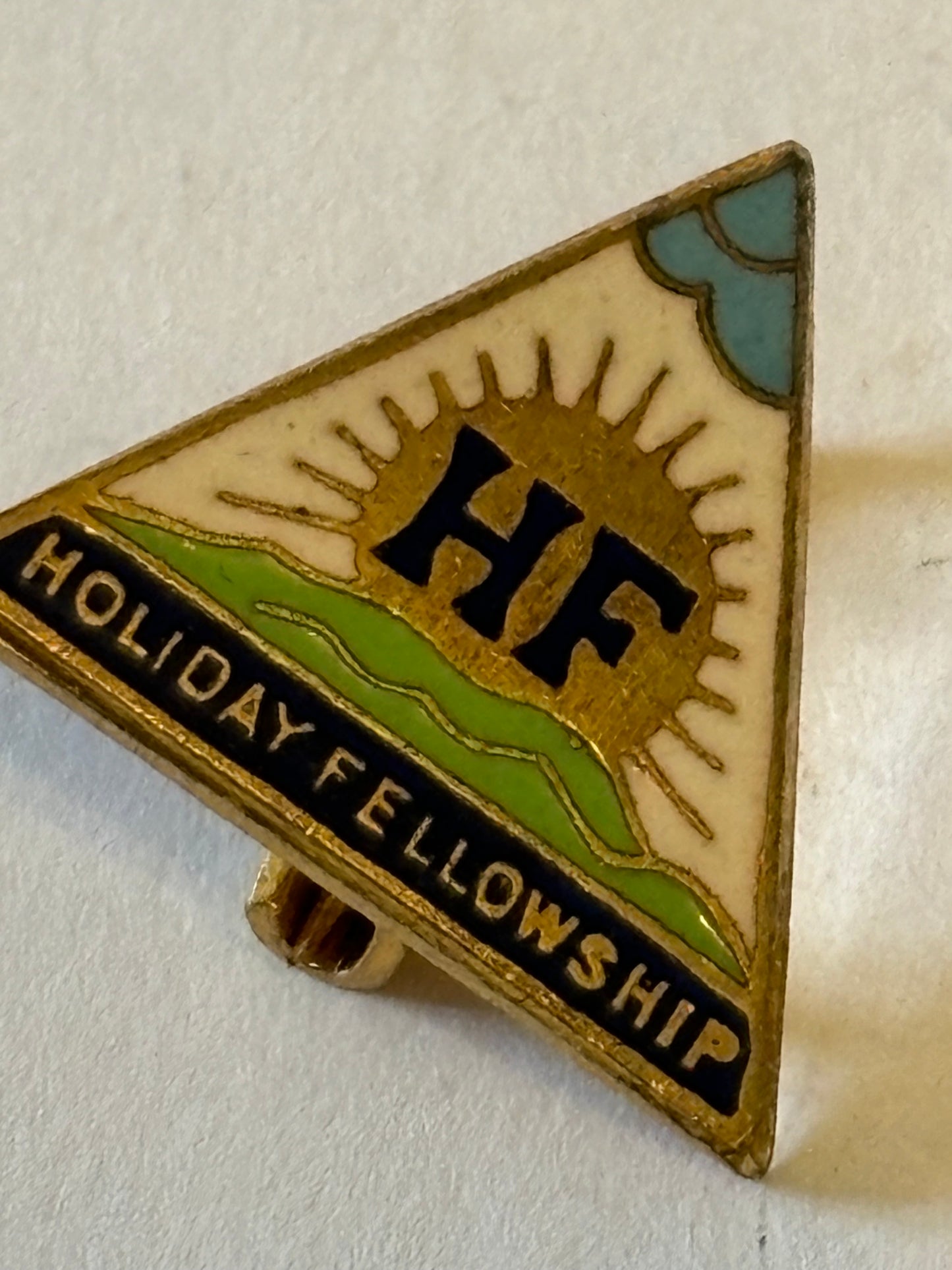 Small vintage triangular Holiday Fellowship pin badge