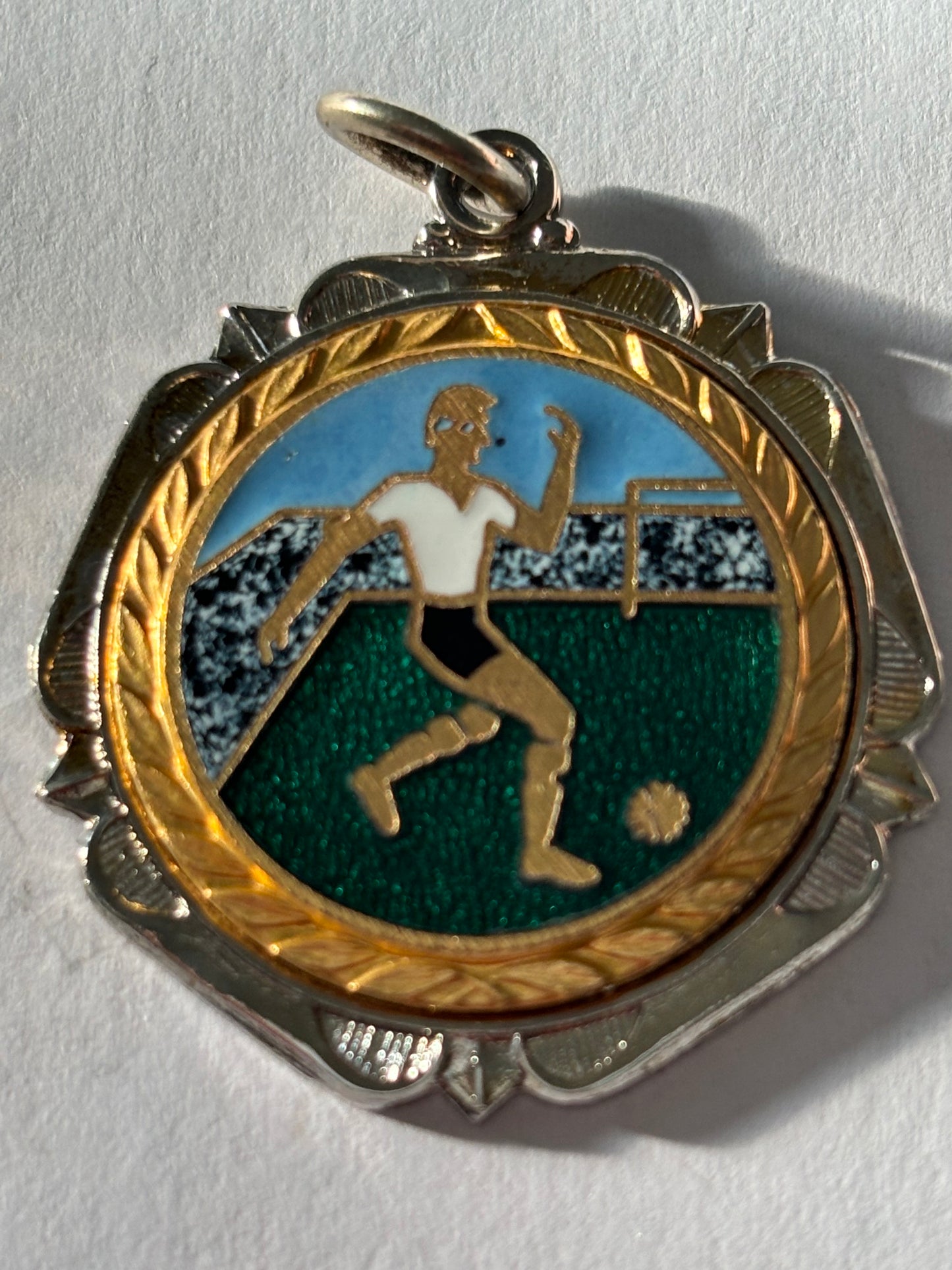 Small silver metal football medal