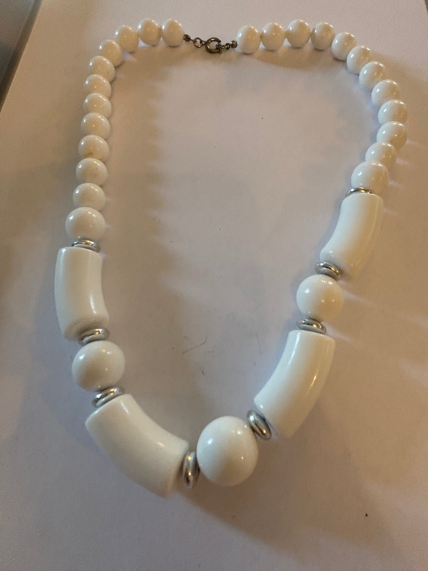 White and tube like large beaded necklace