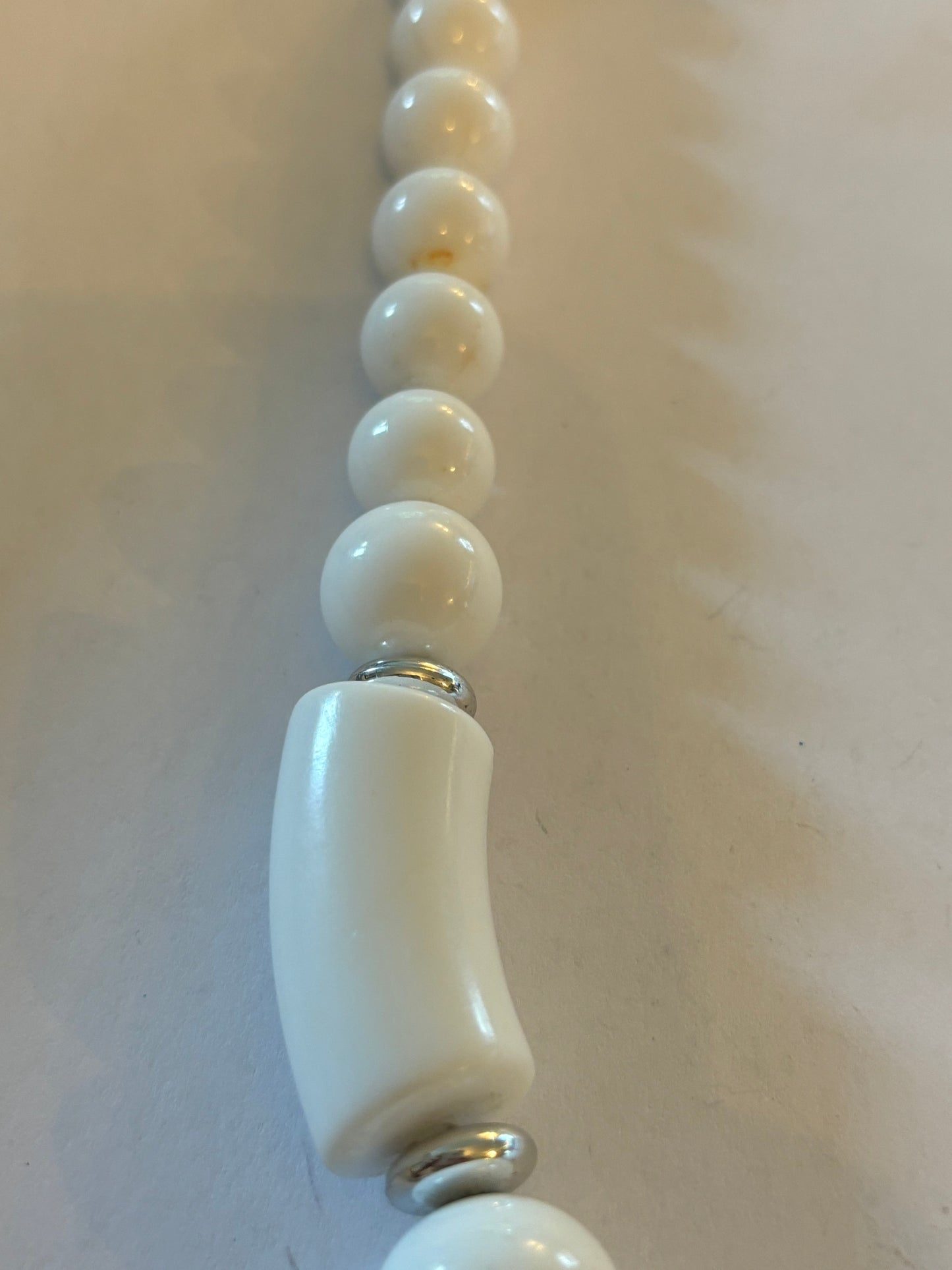 White and tube like large beaded necklace